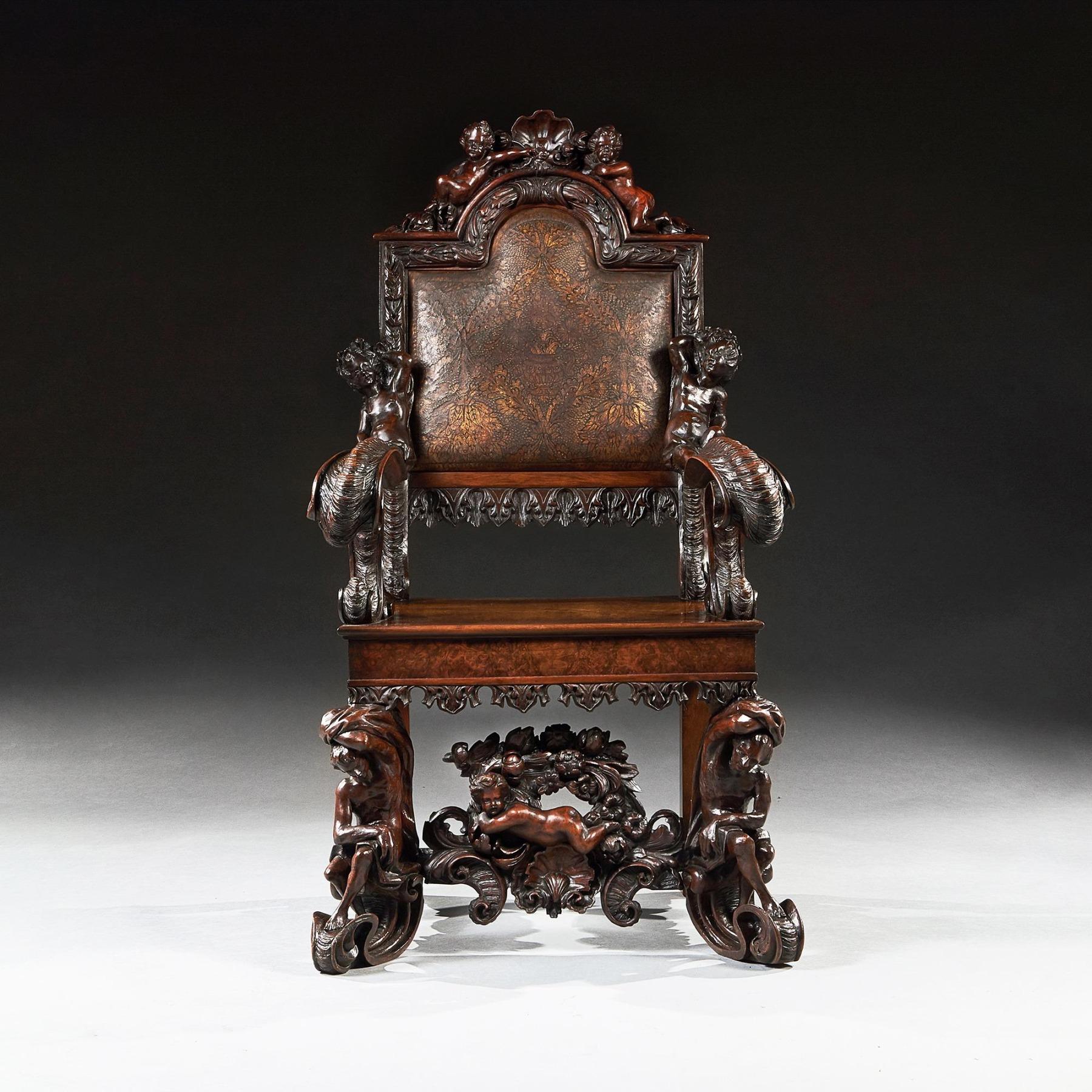 An exhibition quality grand Italian walnut armchair carved in the Baroque style after Andrea Brustolon, possibly by the great Florentine carver Luigi Frullini (1839-97).



Italy circa 1850.



The arched toprail carved with reclining putti