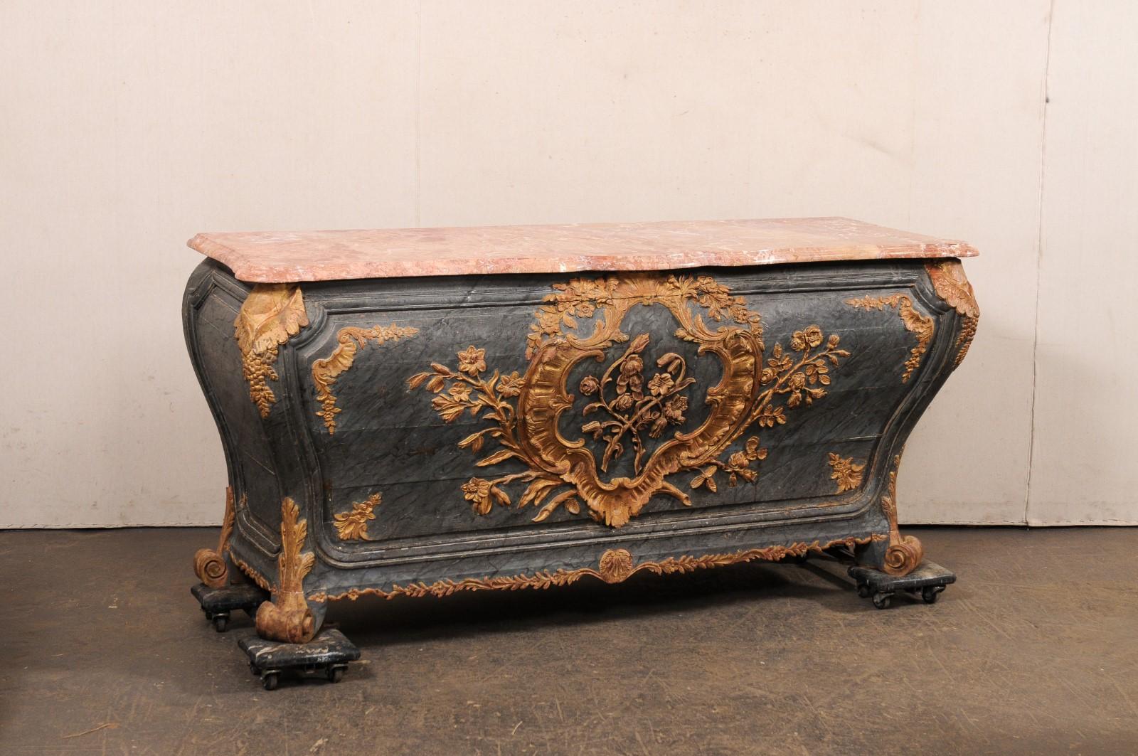 A stunning Italian period Rococo bombe console, with shapely serpentine marble top, from the 18th century. This antique console from Italy is robust piece with its elegantly swelling bombe shape and approximate 6.25 ft long width. The salmon colored