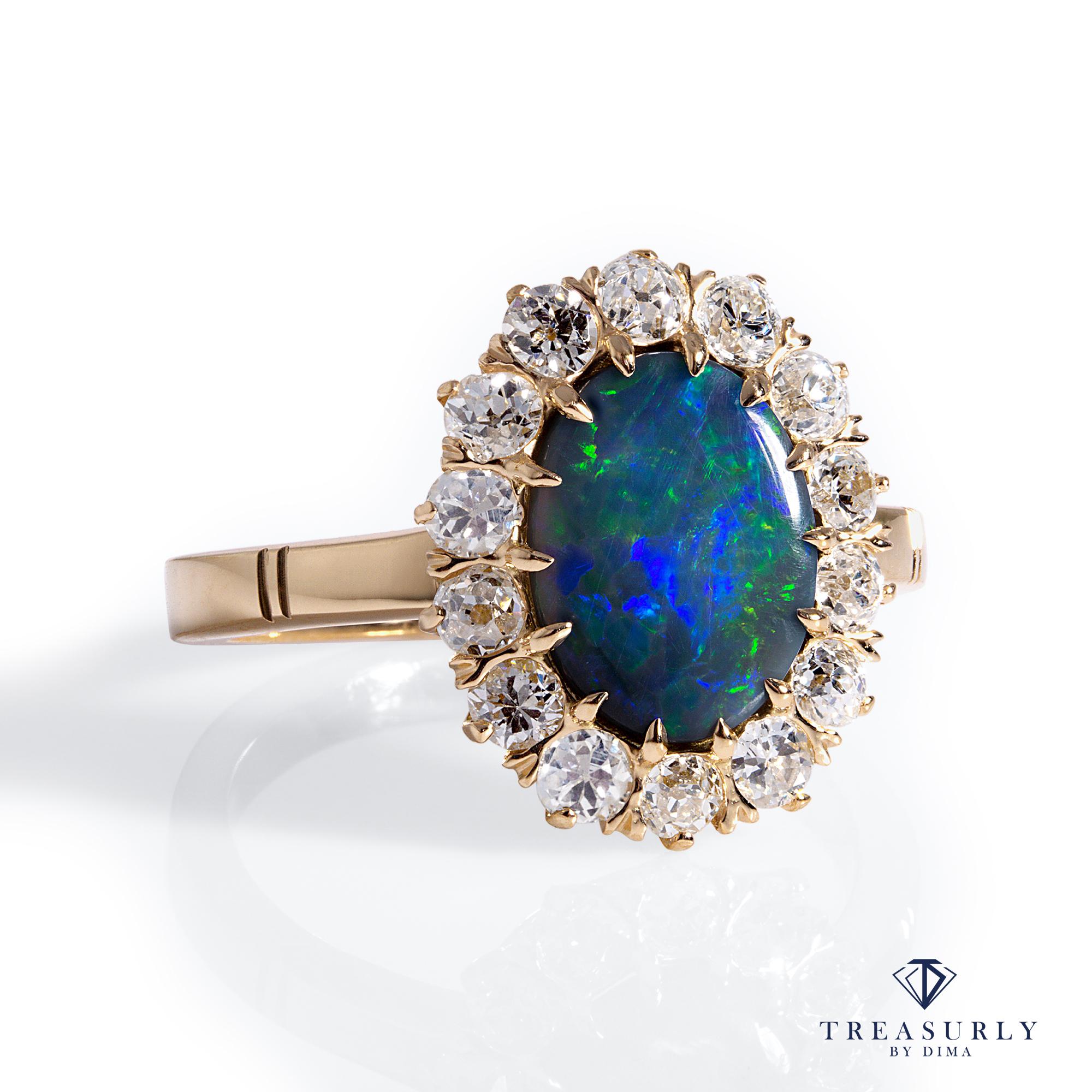 A Beautiful Classic VICTORIAN Black Australian Opal and Diamond Cluster Flower shaped Ring in 18K Yellow Gold.

Highly prized and sought after by kings, emperors, maharajas and sultans, the majestic Opal has been desired throughout the ages. From