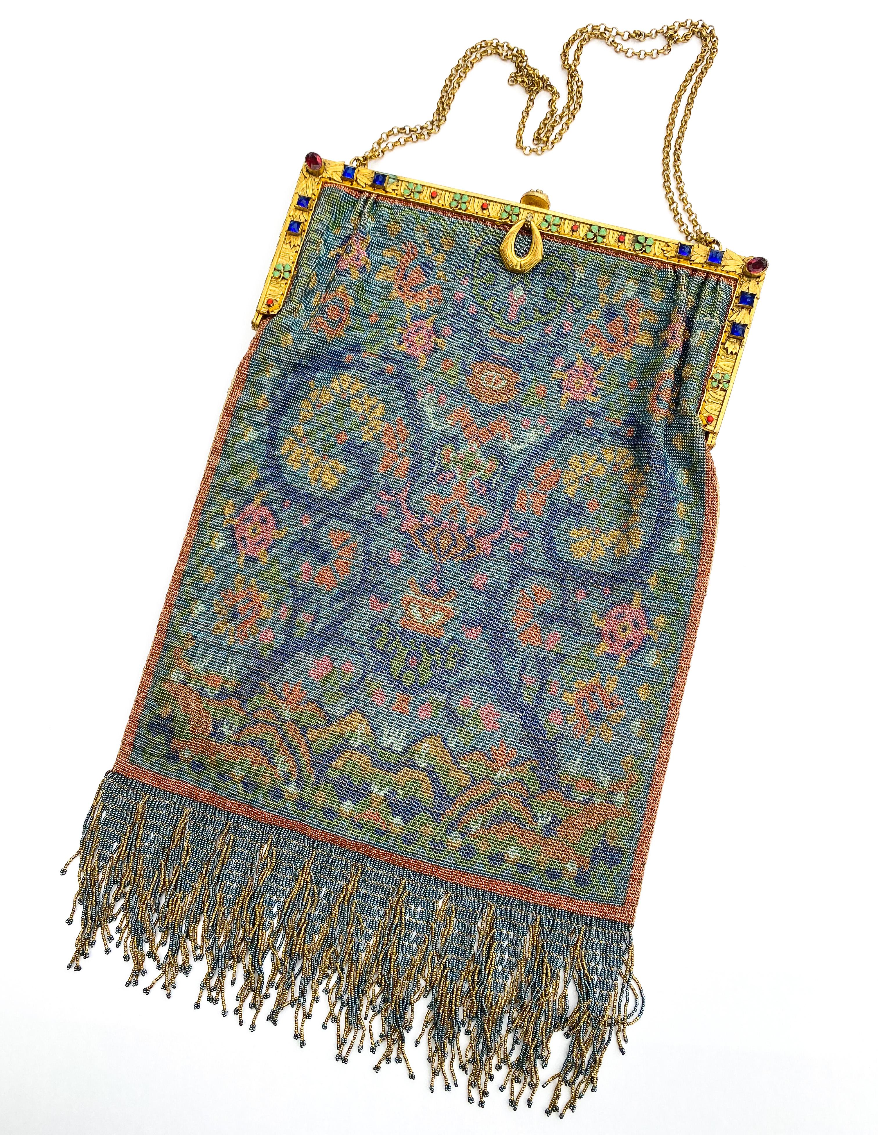 A very fine and detailed large micro beaded bag, with exquisite detail and nuanced colouring, still fresh and intact. Gently gleaming with a sumptuous array of colours, the bag has a gilt metal frame, adorned with coloured pastes and enamelled four