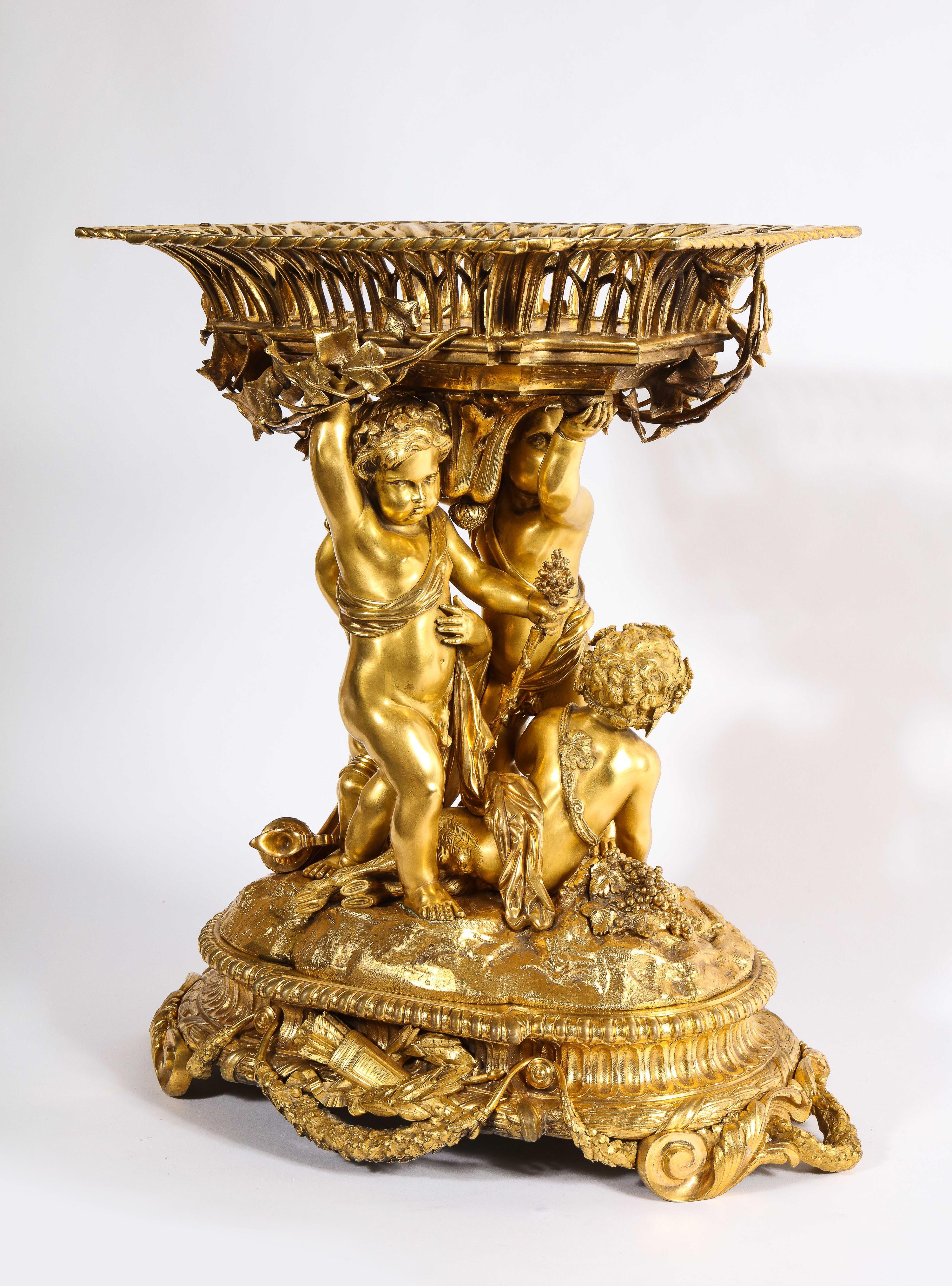 An exquisite Napoleon III French ormolu figural basket centerpiece, Circa 1880, Attributed to Alfred Emmanuel Louis Beurdeley.

Depicting four mercury-gilded bronze ormolu cherubs holding a basket, the base with trophies and scrolling. 

This