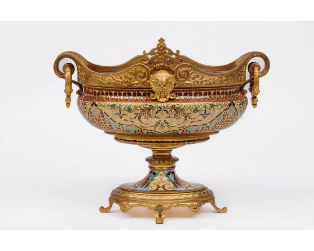An Exquisite Pair of French 19th Century Ormolu and Champleve Enamel / Centerpieces Jardinieres, circa 1875
 
Rendered in the sophisticated style of the celebrated Ferdinand Barbedienne, each jardinière features a graceful bulbous outline,