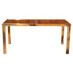 An extendable brass dining table with smoked glass, attr. Milo Baughman, 20th c