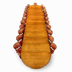 An extensive burled and figured pollard oak dining table and chairs by Gillows