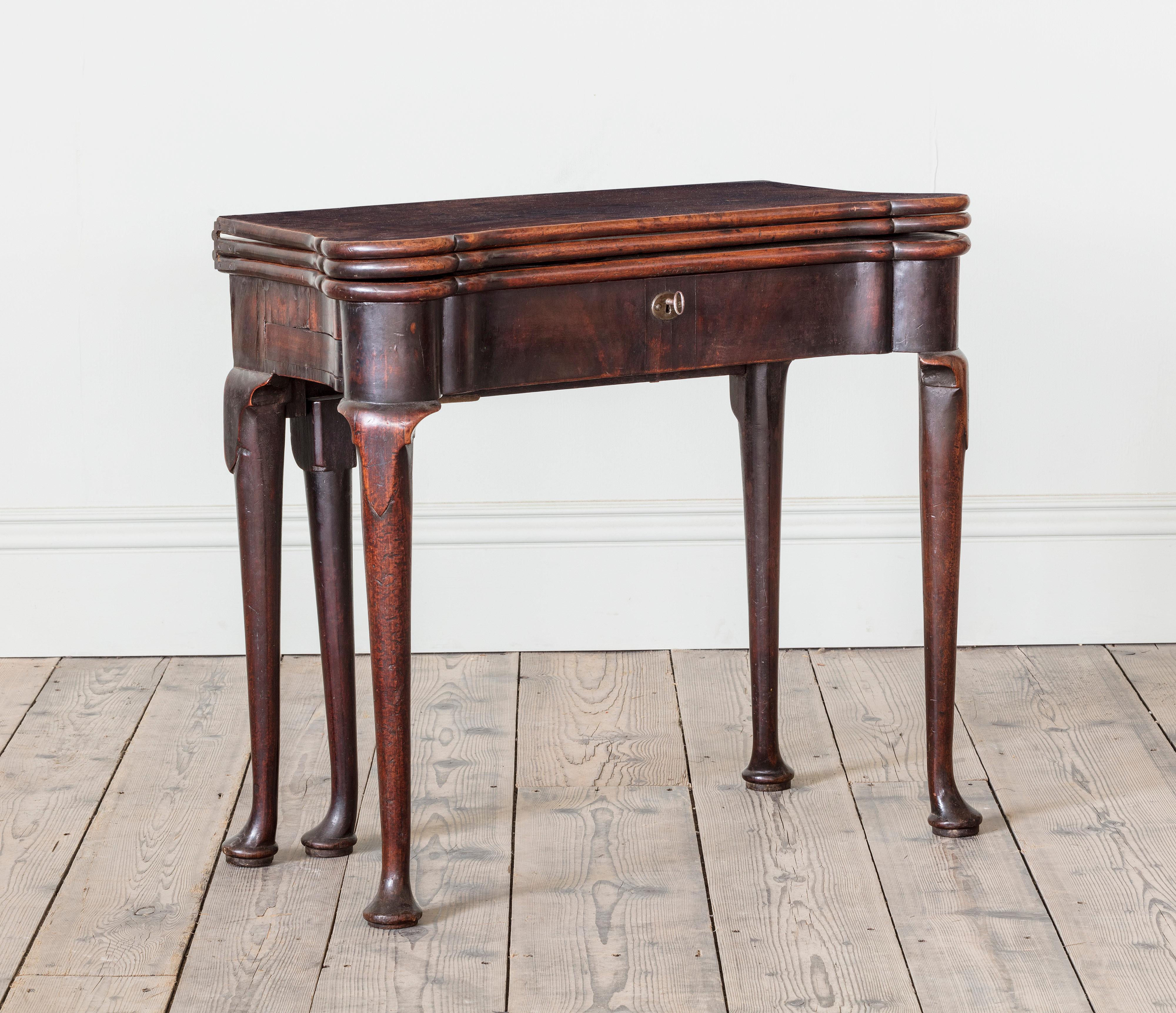 An Extraordinary George I Triple Leaf Mahogany Games Table

The top fitted with three tiers, the 1st for back backgammon and writing, the second for cards and the third for tea, resting on cabriole legs with pad feet,  retaining the most fantastic
