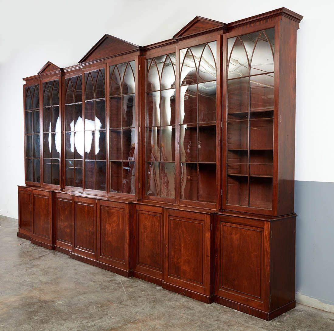 Straordinario mobile del XVIII secolo con triplice finestra vetrata con apertura a strappo sopra una serie inferiore di porte a gradini, sormontate da un architrave modanato a ogiva con tre frontoni a triangolo, il tutto in mogano a grana fine.