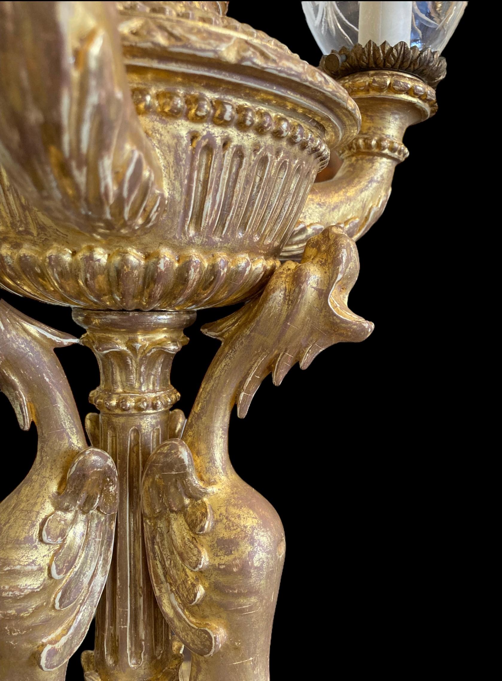 Carved An extremely decorative giltwood three light table lamp For Sale