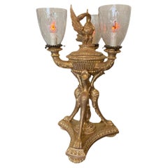 An extremely decorative giltwood three light table lamp