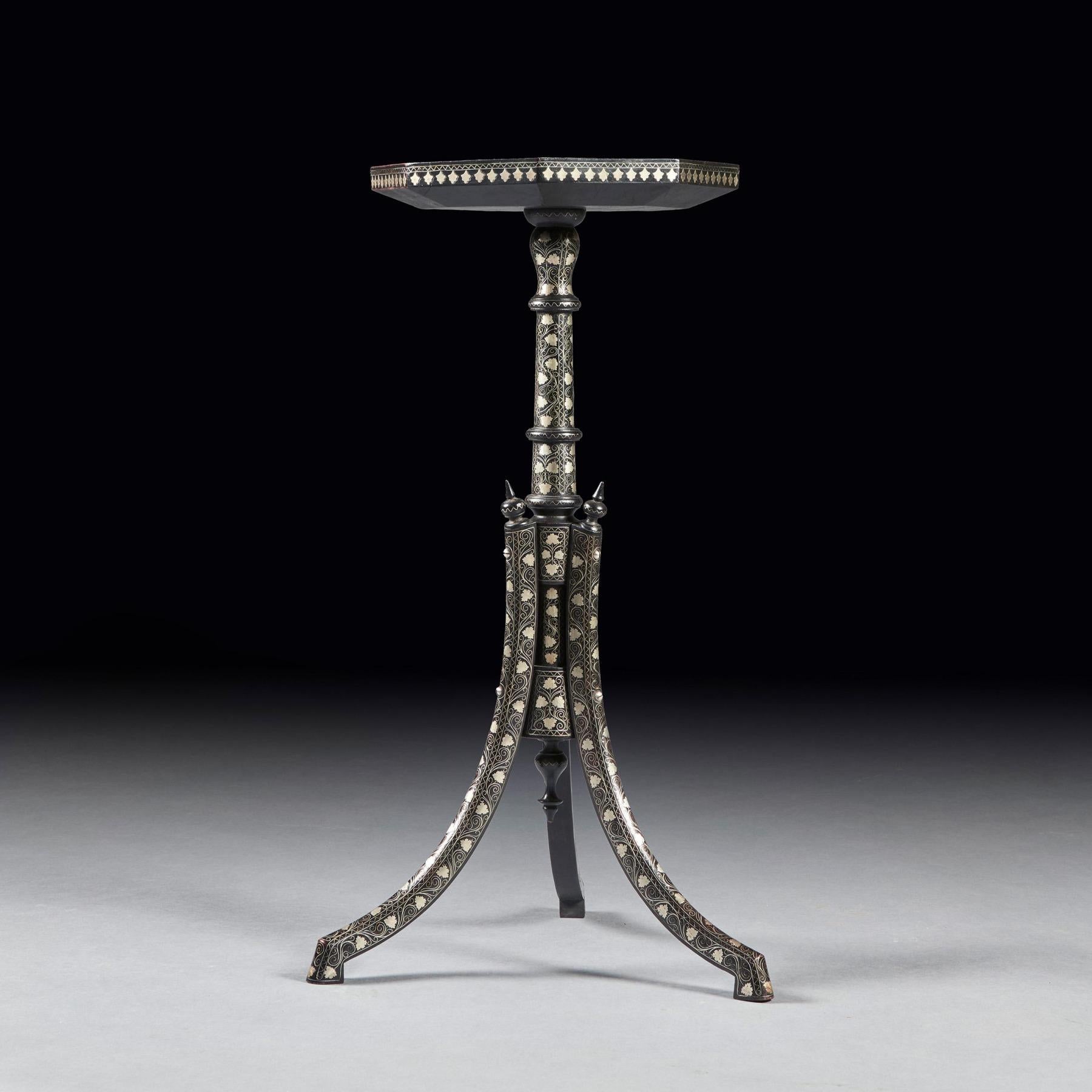 An extremely fine silver inlaid coffee table / tripod table attributed to the Armenian maker, Vortik Potikian Afyonkarahisar.

Turkey Cira 1900.

The silver inlaid octagonal top with central radiating ‘rosace’ framed by four borders of scrolling