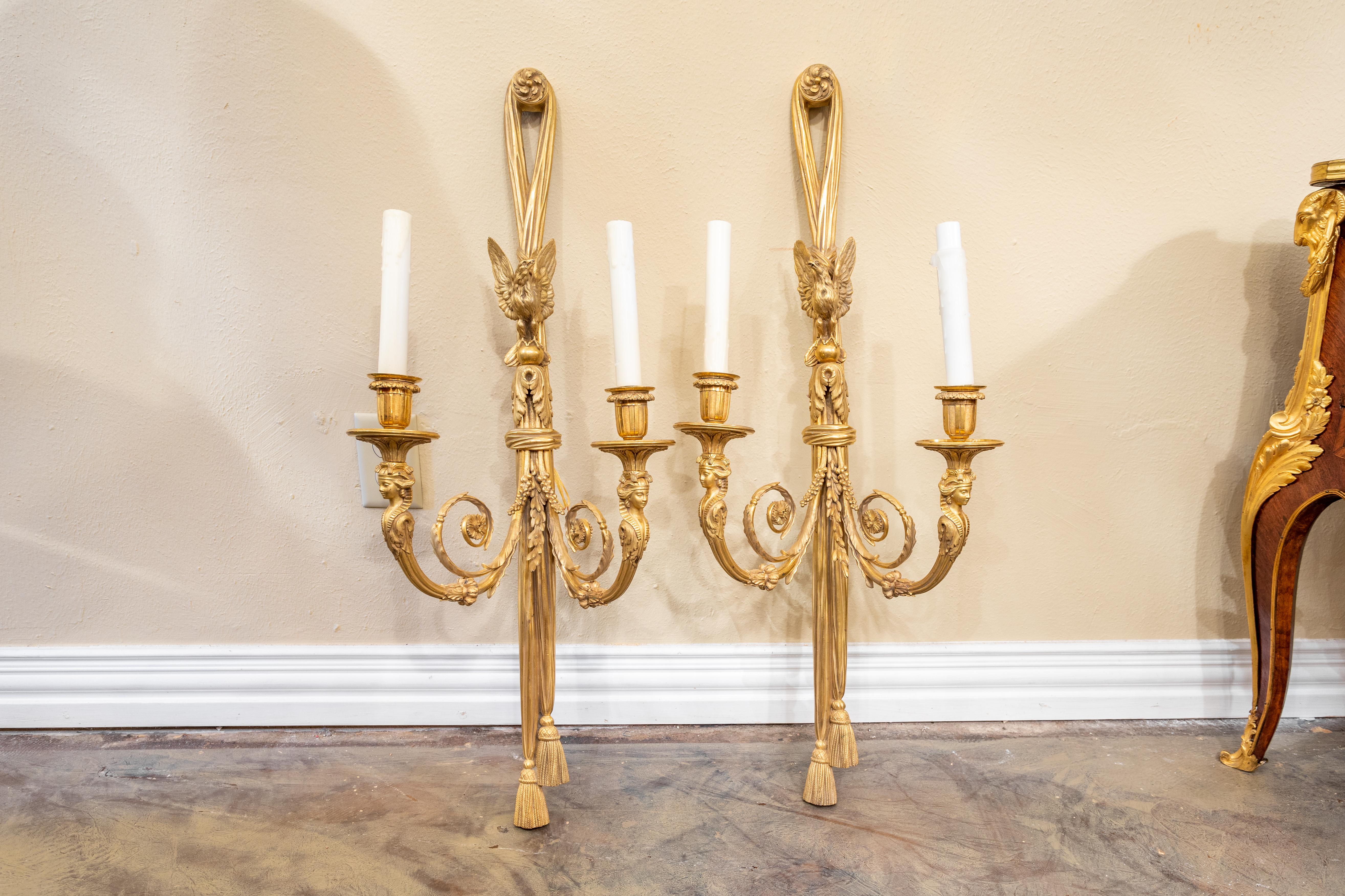 A very fine pair of 19th century French Empire gilt bronze large two light sconces. Fine Egyptian heads below the candles with a finely cast Eagle at the top and tassels at the bottom.