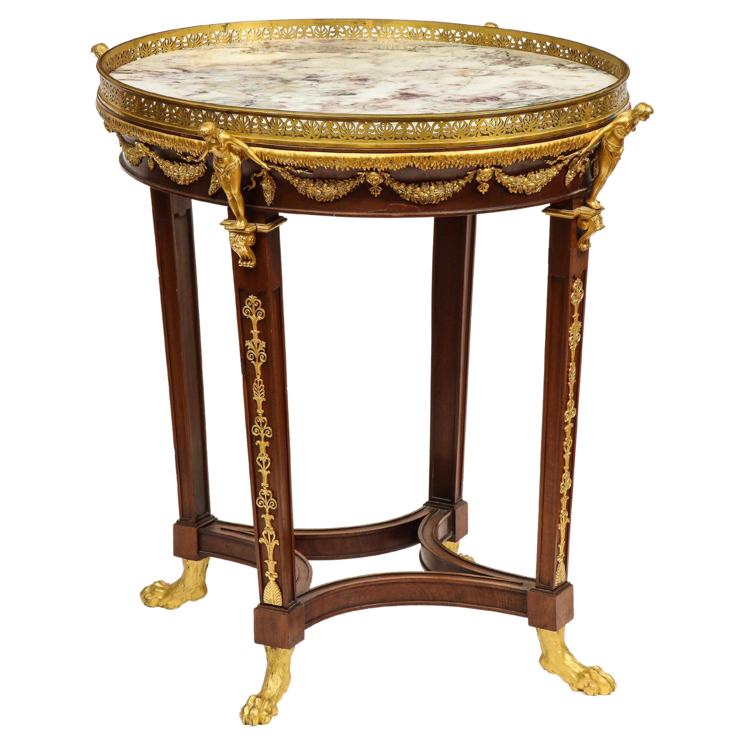 An extremely fine Russian Empire Ormolu Mounted Mahogany center table, circa 1820-1830.

Very finely mounted with crisp ormolu throughout, with bronze female figures, foliate scrolling, lions head mounts, and bronze paw feet. With the original