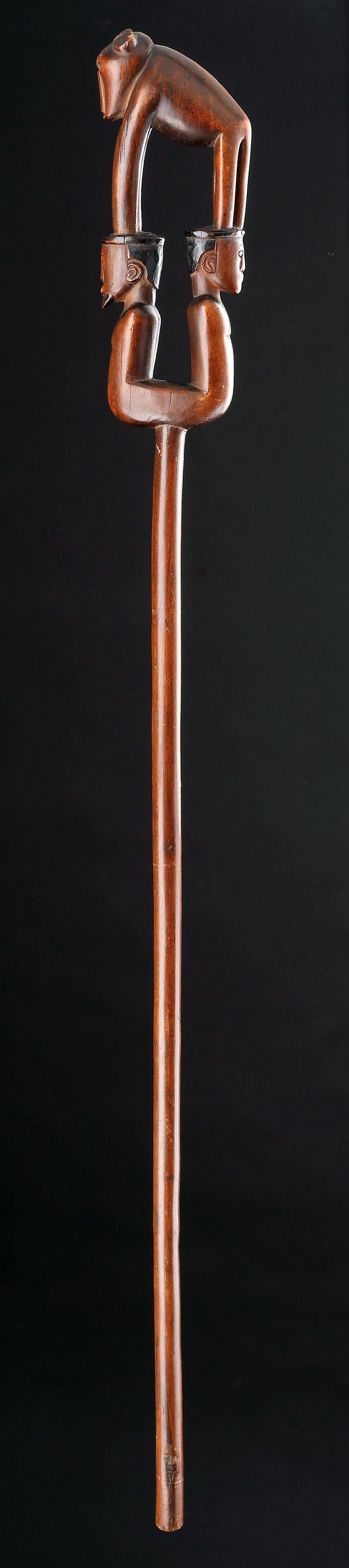 A Rare and Extremely Fine South African Tsonga Prestige Staff by the ‘Baboon Master’
Depicting a Zulu elder wearing a head-ring 
Superb silky reddish brown patina

Late 19th Century 

Size: 104cm high - 41 ins high 

These staffs were used by