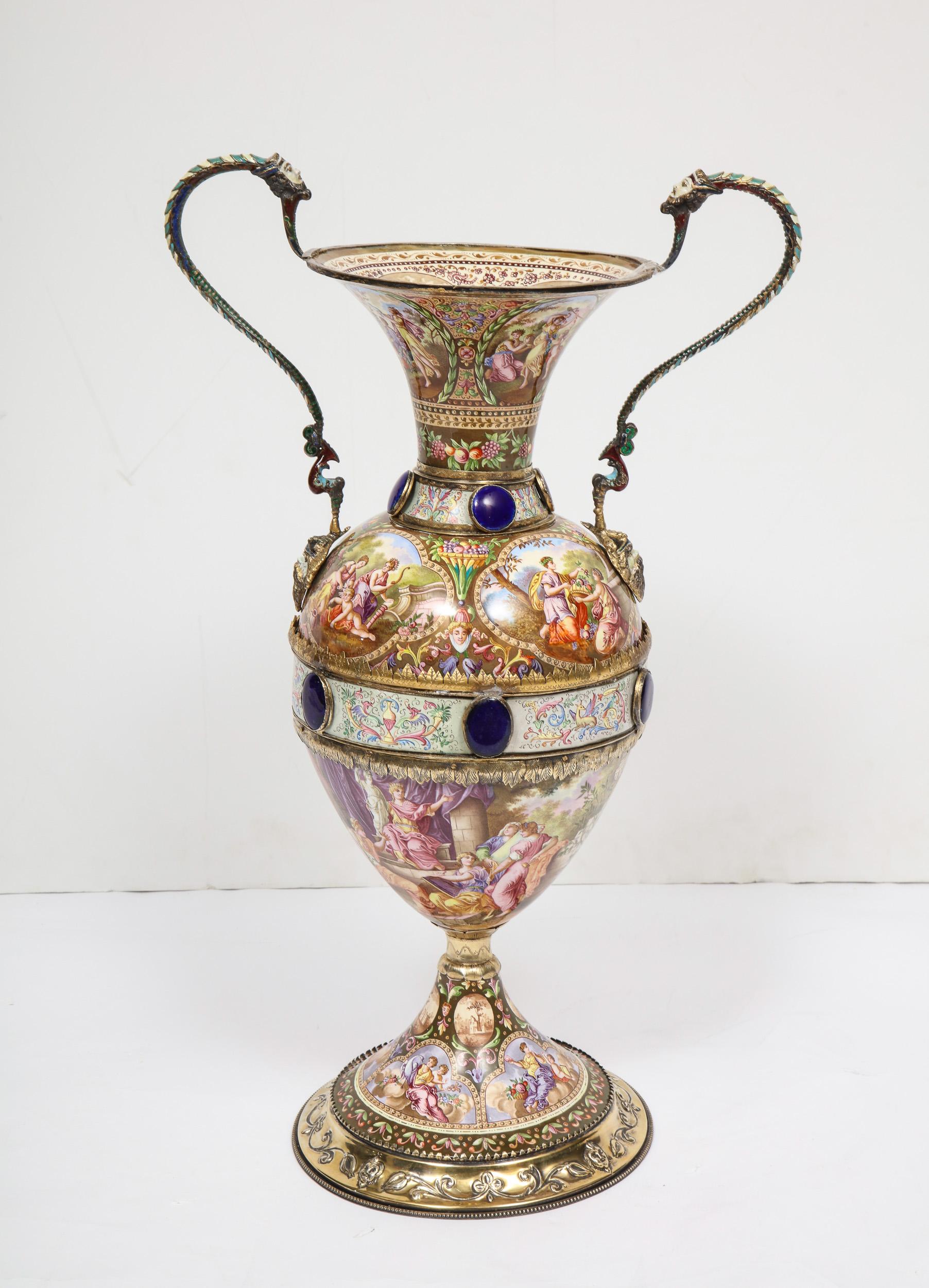 An extremely large Austrian silver and Viennese enamel twin handled vase, 1880.
In the manner of Herman Bohm.

The enameling on this vase is of outstanding quality. Very Fine quality silver mounts throughout. With blue enamel roundels, and