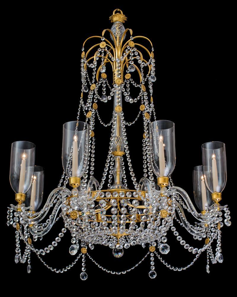 An extremely rare pair of English Regency period eight-light cut glass and ormolu-mounted chandelierS of the finest quality the shaft centred by a tapered slice and diamond cut stem piece surmounted by a drop hung ormolu palm tree spray, this