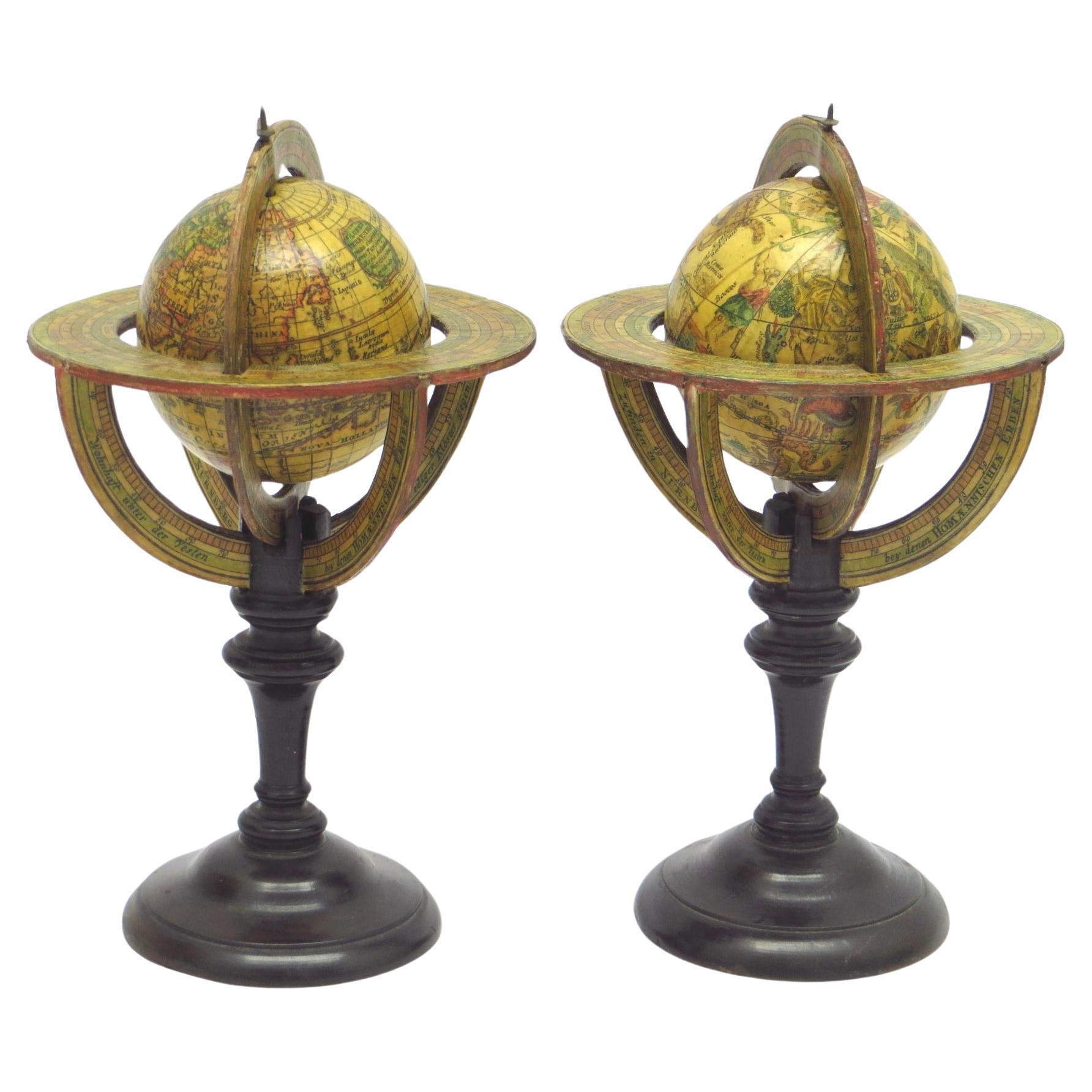 An extremely rare pair of miniature globes by Johann Baptist Homann For Sale