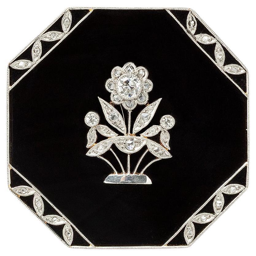 Eine Art Deco-Brosche aus Gold und Platin mit Onyx und Diamant