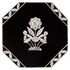 An Gold and Platinum Art Deco Brooch with Onyx and Diamond
