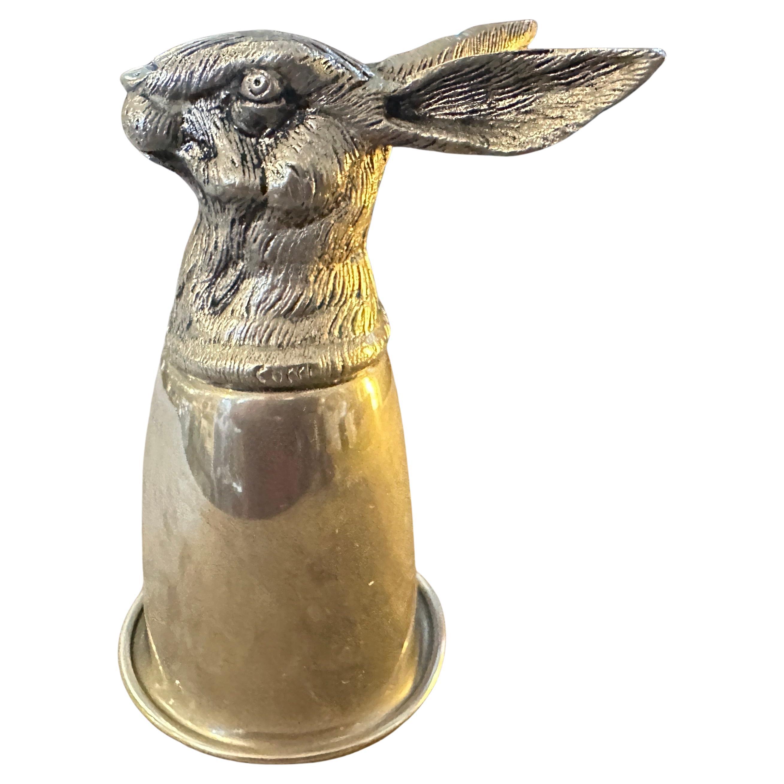 This hallmarked Gucci stirrup cup from the 1980s is a luxurious piece of silver-plated barware that combines functionality with equestrian-themed elegance.
The upper part of the cup is formed as a realistic and finely sculpted rabbit head,
