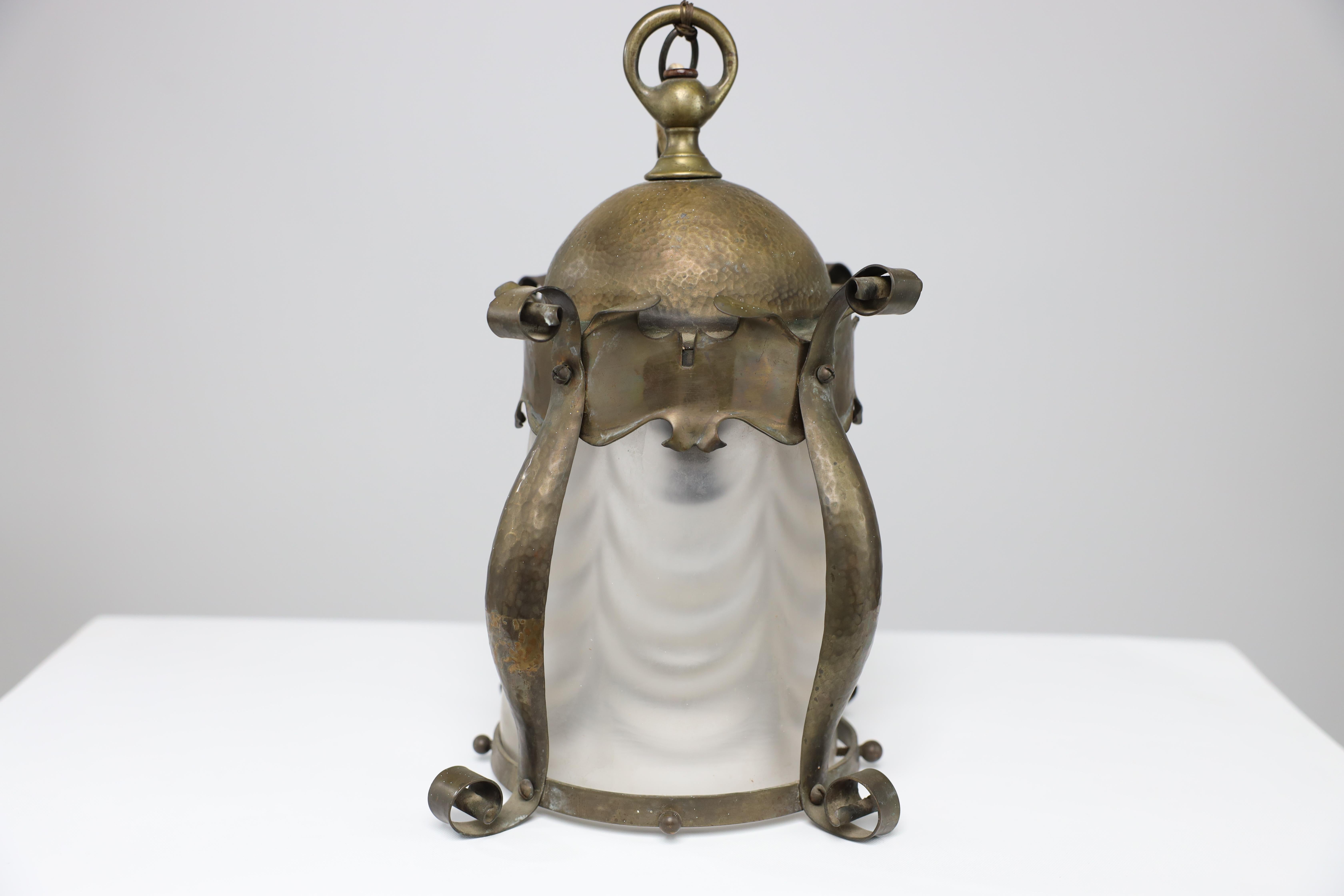 An Arts and Crafts hammered brass lantern with original opaque ribbed glass liner.
I also have another one in stock identical but half the size.