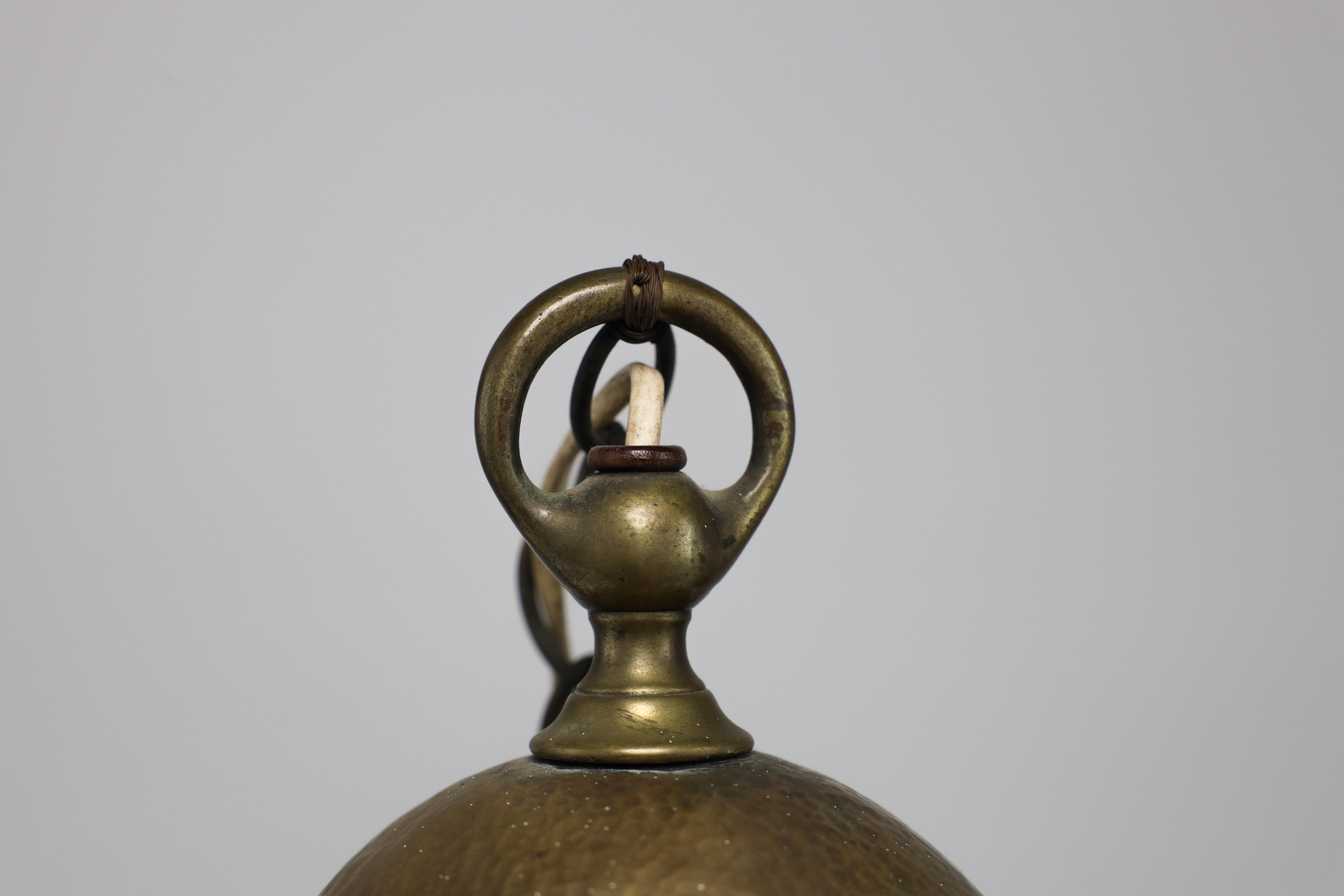 English An Arts & Crafts hammered brass lantern with original opaque ribbed glass liner. For Sale