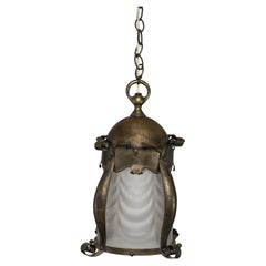 Antique An Arts & Crafts hammered brass lantern with original opaque ribbed glass liner.