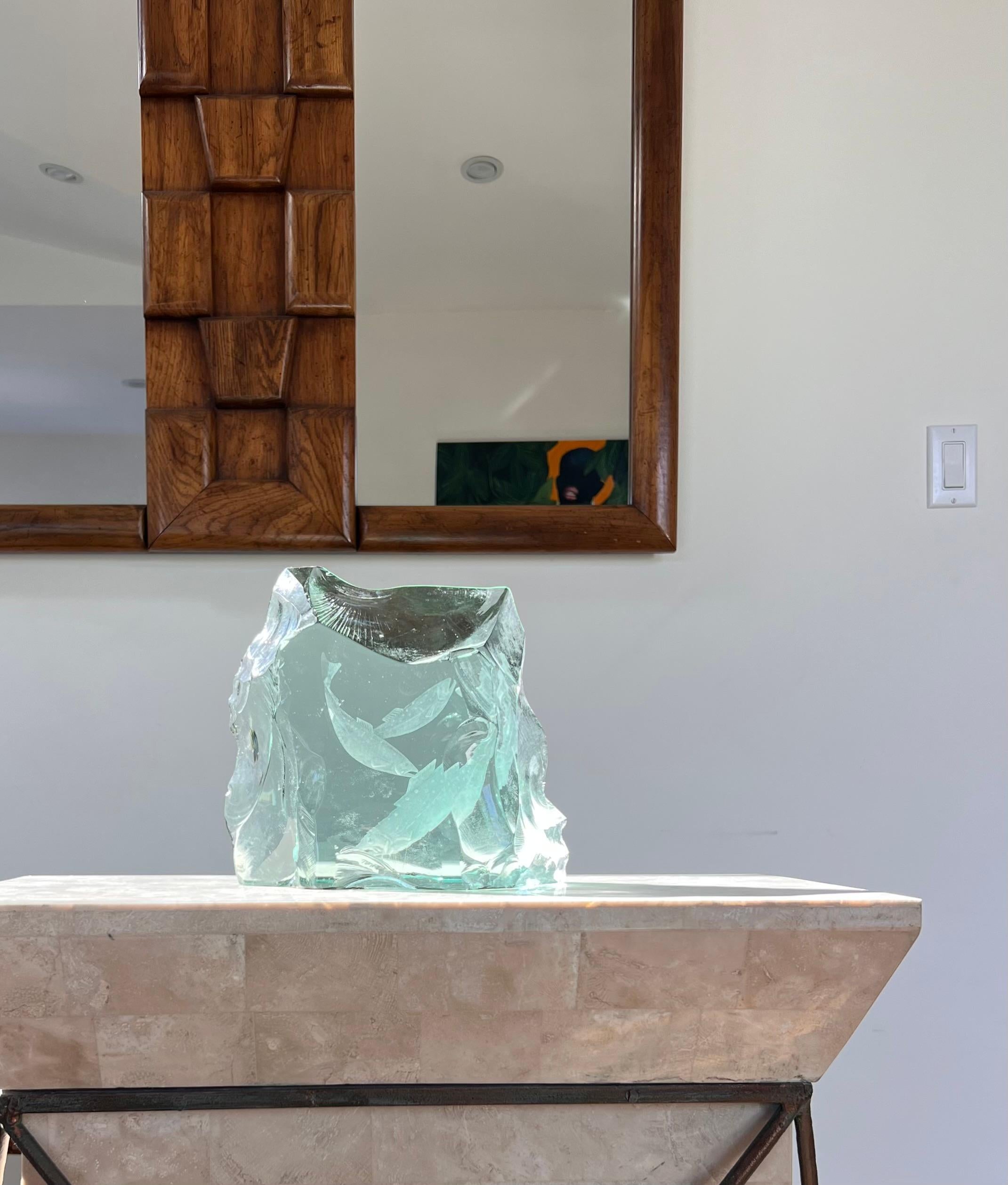 A Swedish postmodern art glass “ice block” sculpture featuring highly carved fish by Vicke Lindstrand for Kosta Boda, late twentieth century. The etched fish are rendered in glorious detail, while the roughness of the raw glass provides a stark