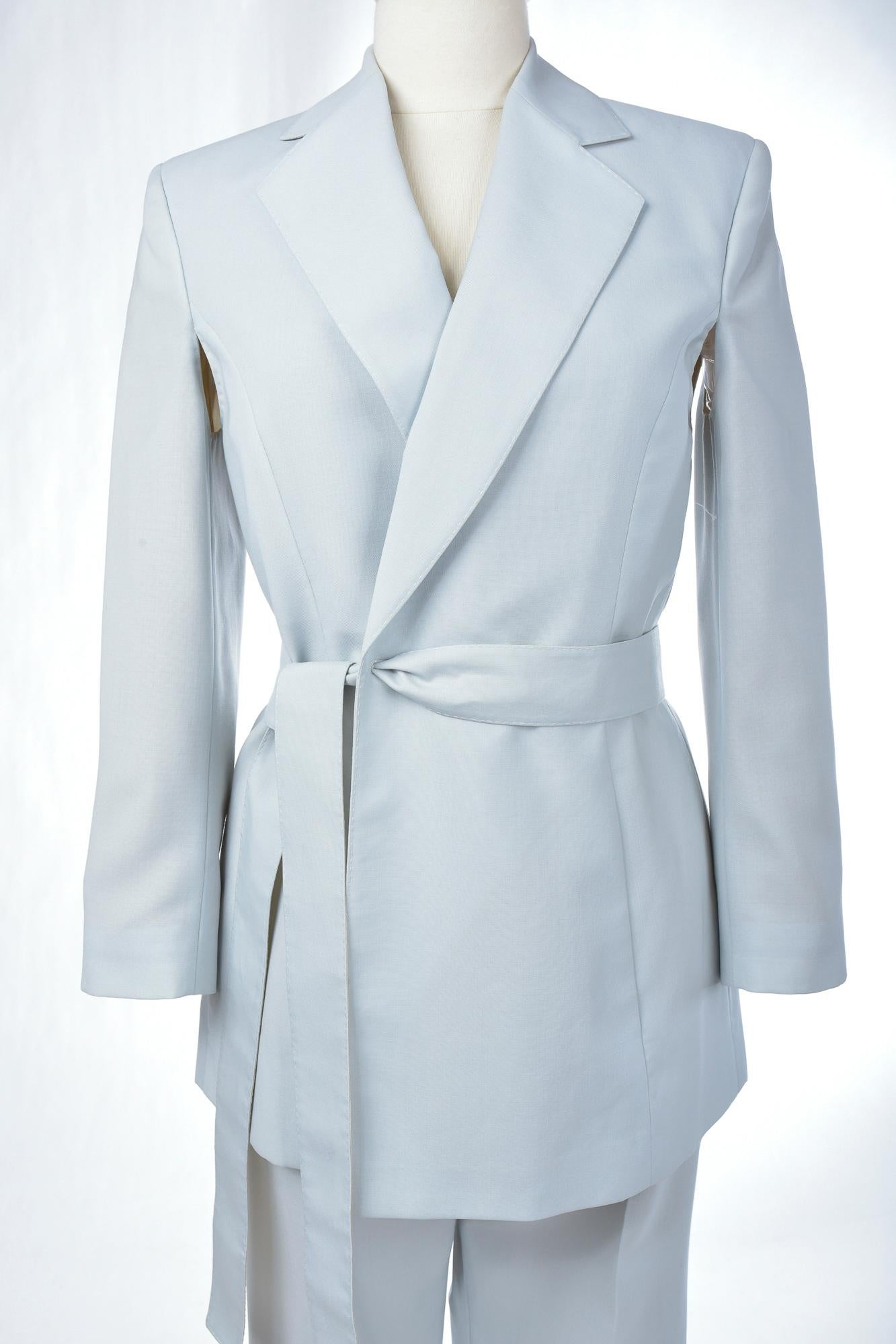 Circa 1995 - 2000
Italy
Elegant Tuxedo Trouser Suit in ice blue virgin wool fabric (100% WV) by the famous Italian designer Mr Gianfranco Ferre (1944 - 2007).  Soft jacket with small epaulettes, long sleeves with armpit holes for ease of movement,