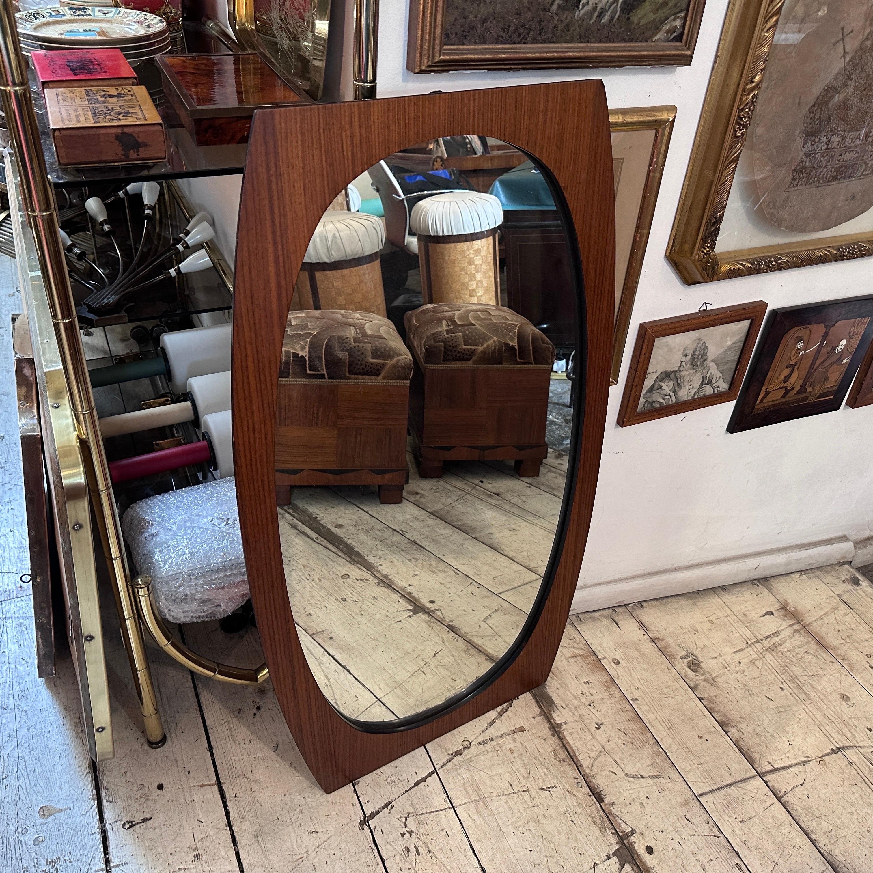 A mid-century modern wood mirror by Gianfranco Frattini is a remarkable piece of design that encapsulates the essence of the era. Gianfranco Frattini, an influential Italian architect and designer, was known for his innovative approach and skillful