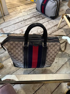 An Iconic 1980s Gucci Monogram Travel Bag with Signature Red and Blue Web Stripe
