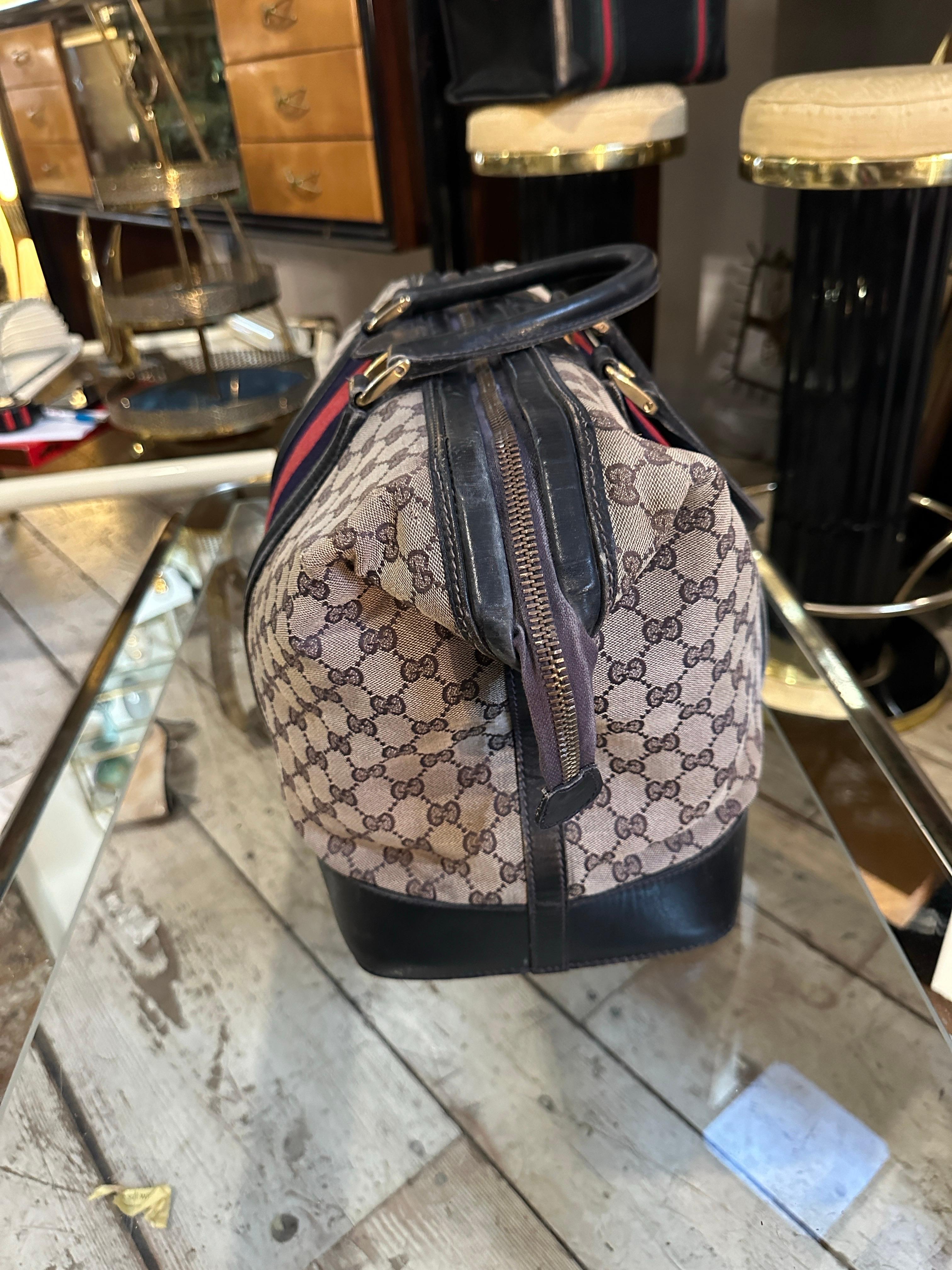 Women's An Iconic 1980s Gucci Monogram Travel Bag with Signature Red and Blue Web Stripe