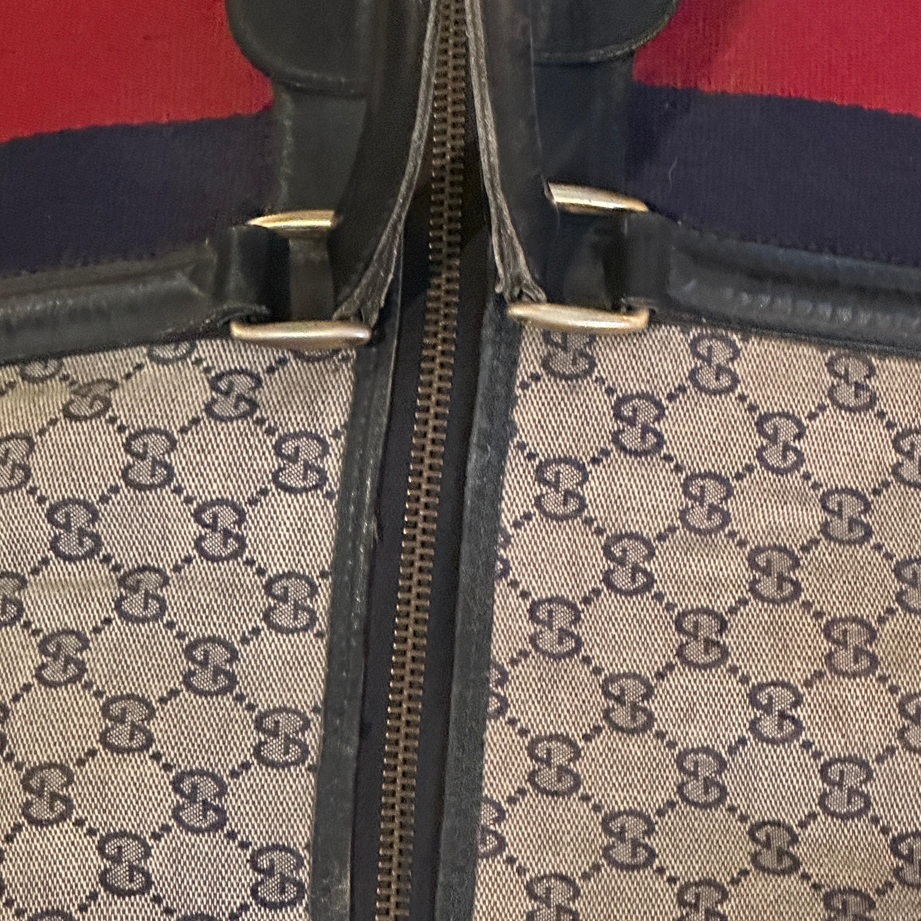 An Iconic 1980s Gucci Monogram Travel Bag with Signature Red and Blue Web Stripe 1