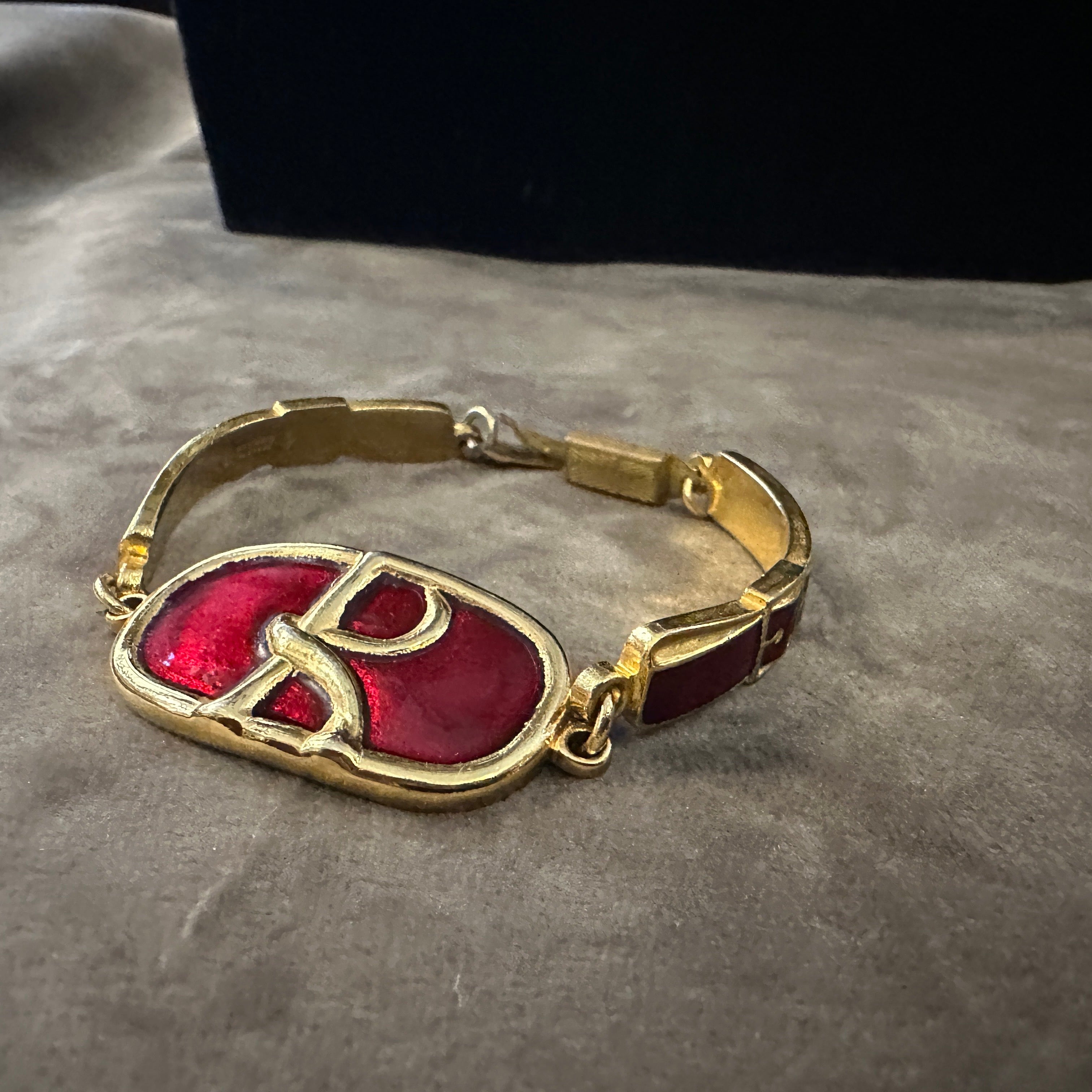 An Iconic 1990s Brass and Red Enamel Bracelet by Roberta di Camerino.
Adorn your wrist with a piece of Italian design history with this captivating 1990s bracelet by Roberta di Camerino. This piece perfectly encapsulates the brand's unique blend of