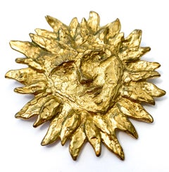 An iconic gilt metal 'Sun face' brooch, Yves Saint Laurent, France, 1980s
