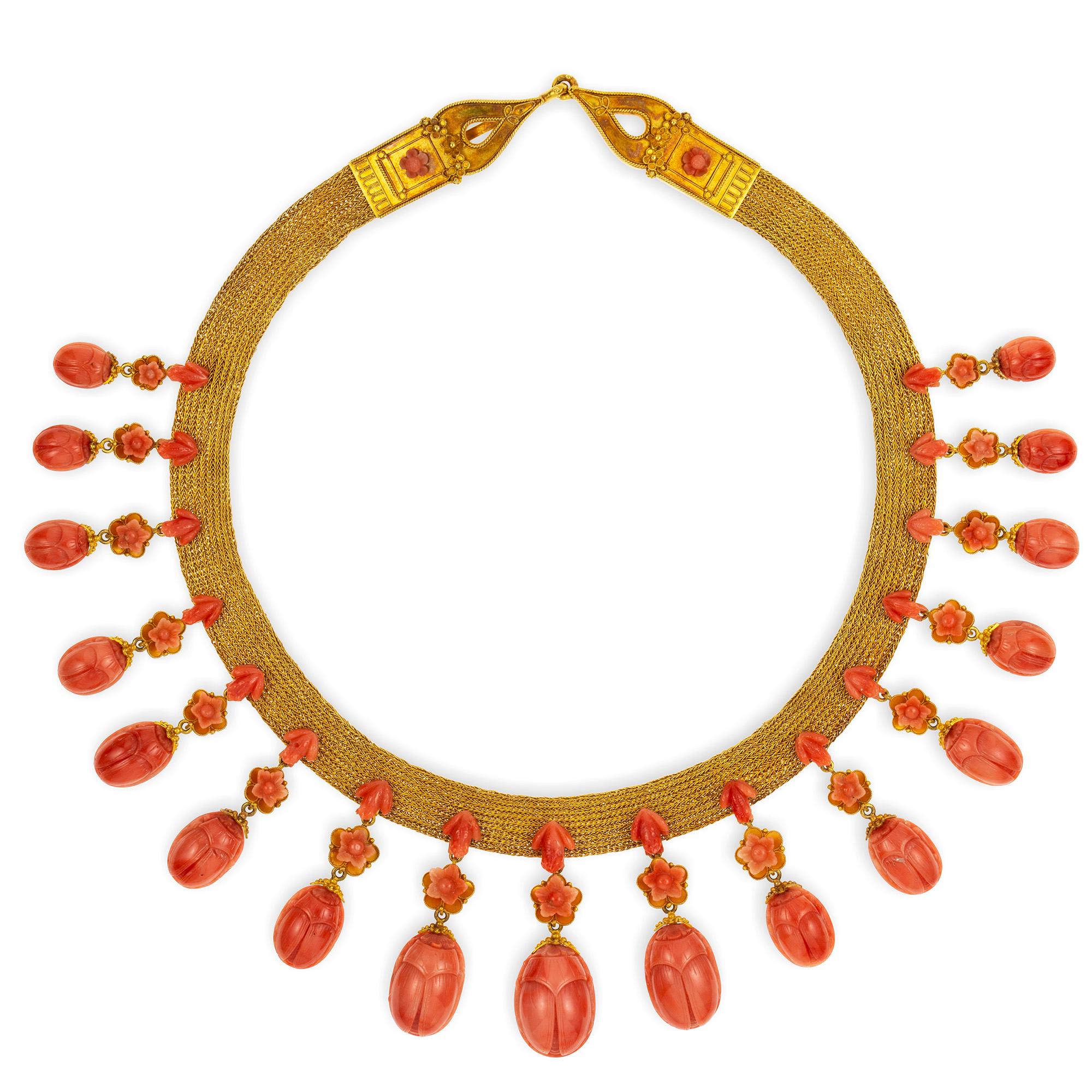 An Important Archaeological Revival coral and gold parure, consisted of a necklace, bracelet, brooch and earrings, the necklace set with seventeen graduating coral scarab beetles, each suspended from a single coral lotus head and gold foliage and a