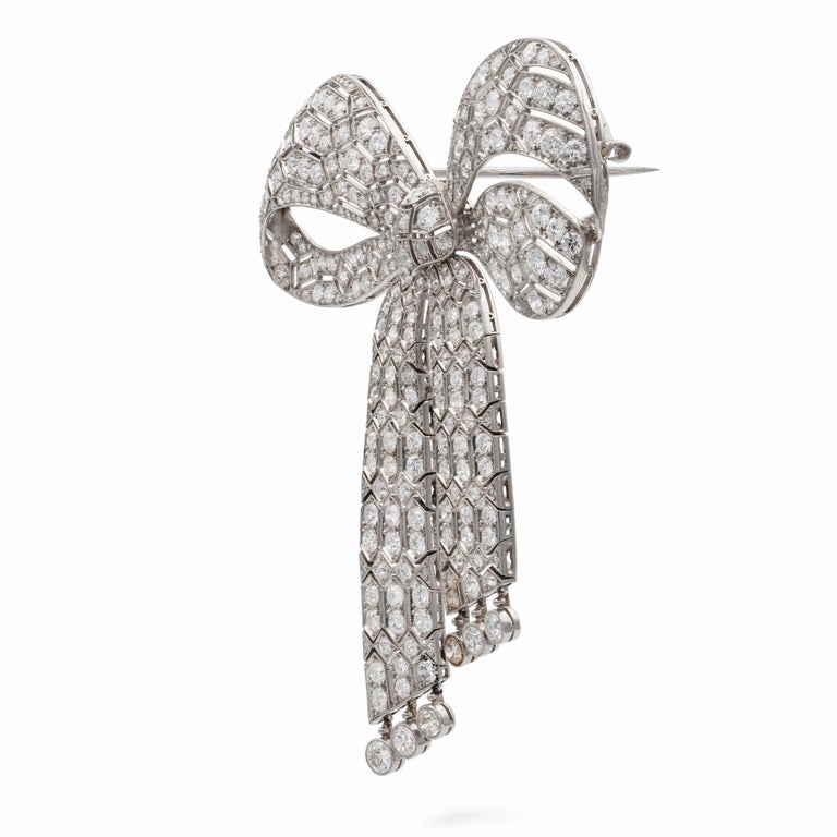 An Important Art Deco diamond bow brooch by Van Cleef & Arpels, the two hundred and eighty-seven old European-cut diamonds estimated to weigh 17 carats in total, millegrain-set in a flexible and openwork design mount in the form of a bow, all made