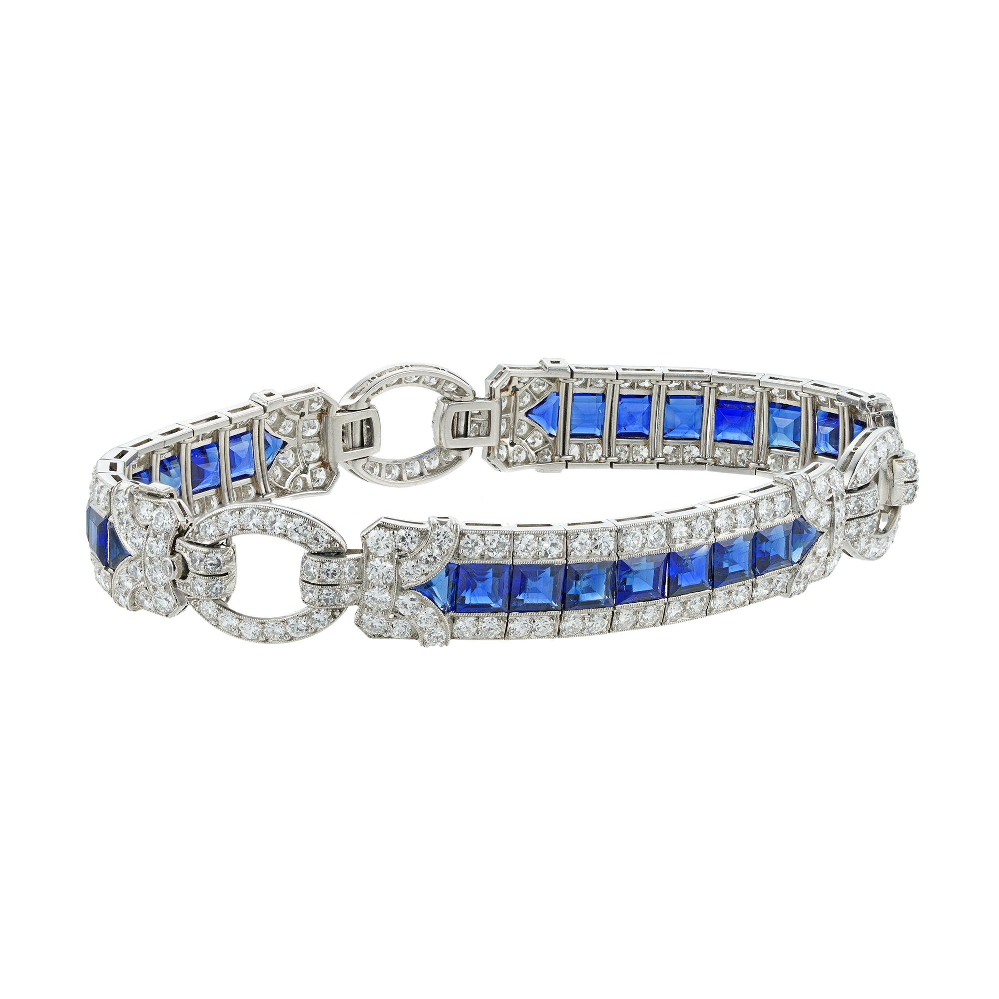 An Important Art Deco sapphire and diamond bracelet by Yard, consisting of three rectangular-shape flexible panels, each with a central row of calibre-cut sapphires surrounded by a diamond-set border of geometric design, connected by three