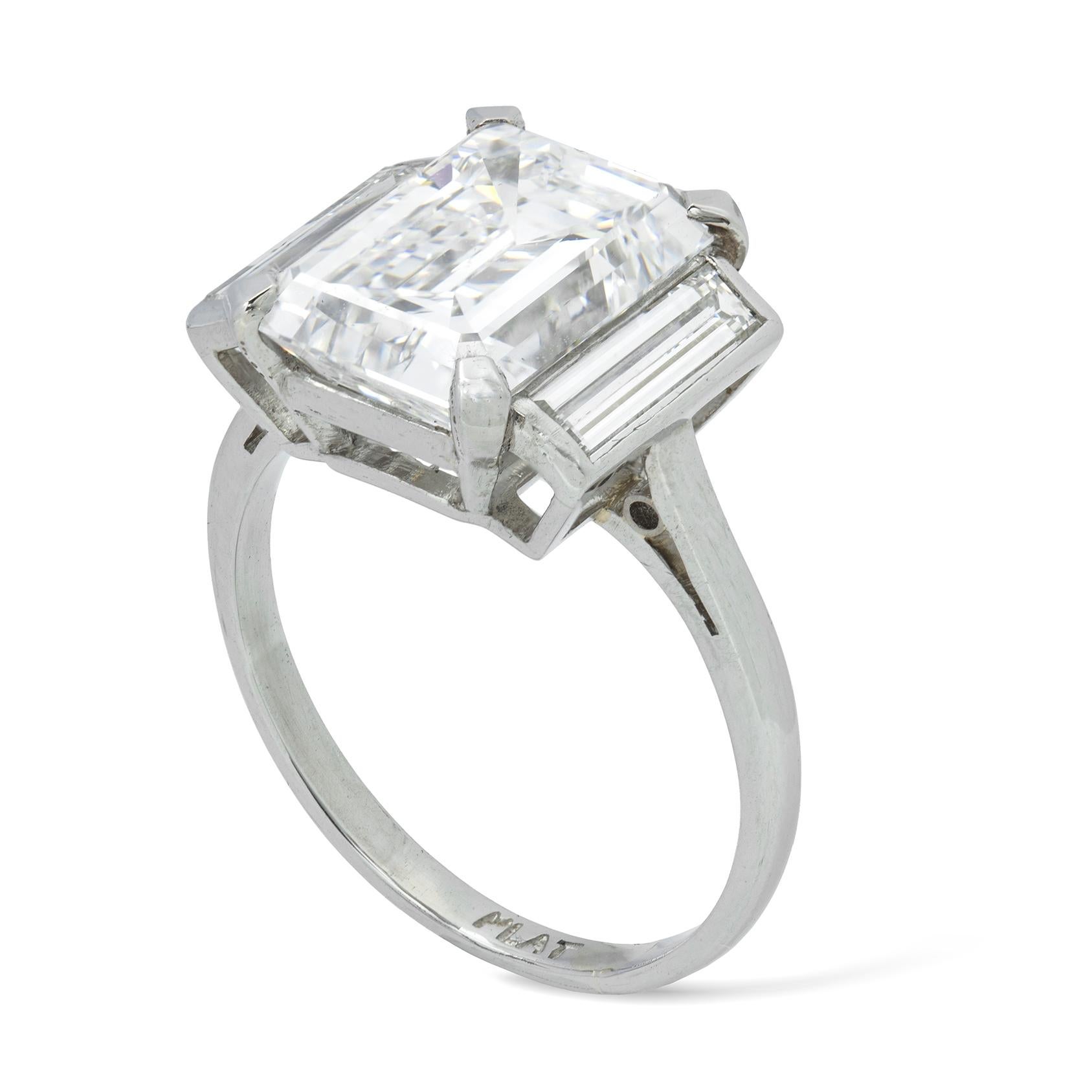 An Important diamond ring, the central emerald-cut diamond accompanied by GIA Report  stating to be 4.12 carats, D colour SI1 clarity, claw set between two baguette-cut diamonds estimated to weigh a total of 0.50 carats, all in a fine platinum