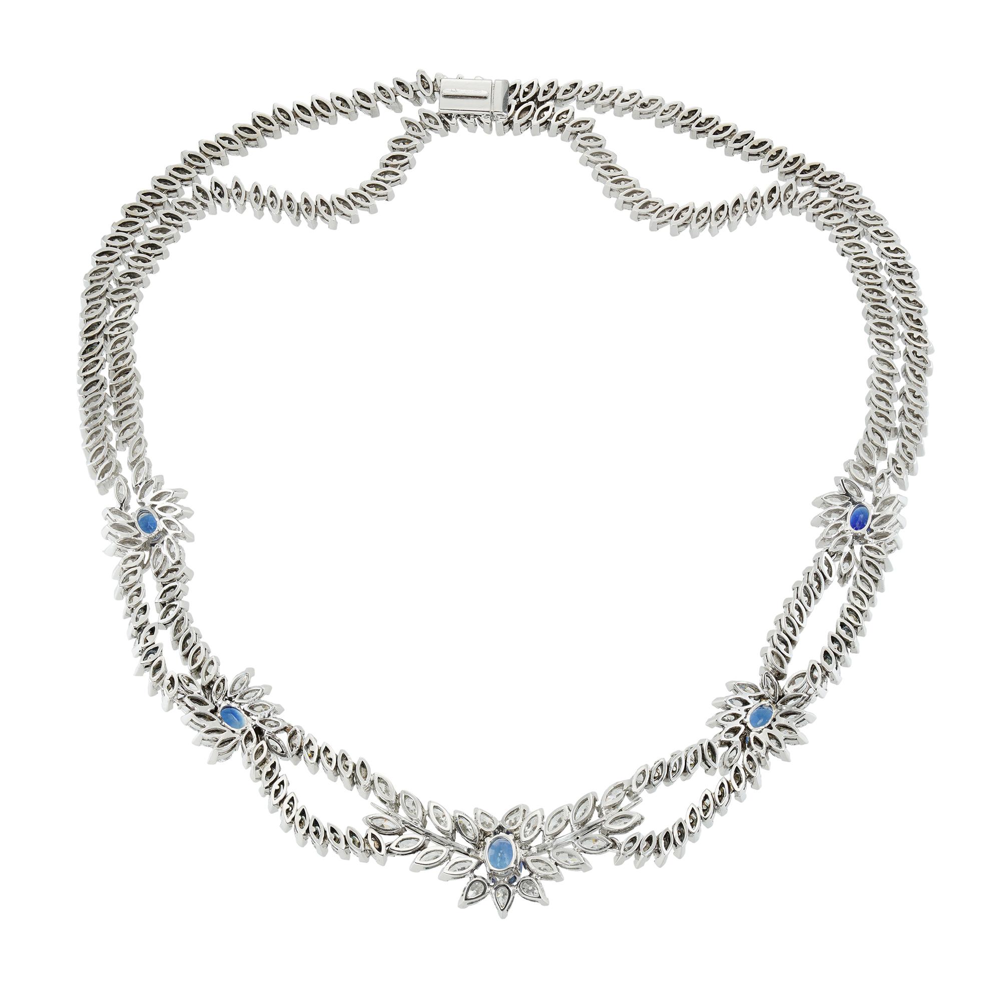 An important early 21st century sapphire and diamond necklace, consisting of five sapphire and diamond clusters, each centrally-set with an oval faceted sapphire to a marquise-cut diamond-set surround, the central cluster flanked by two marquise-cut