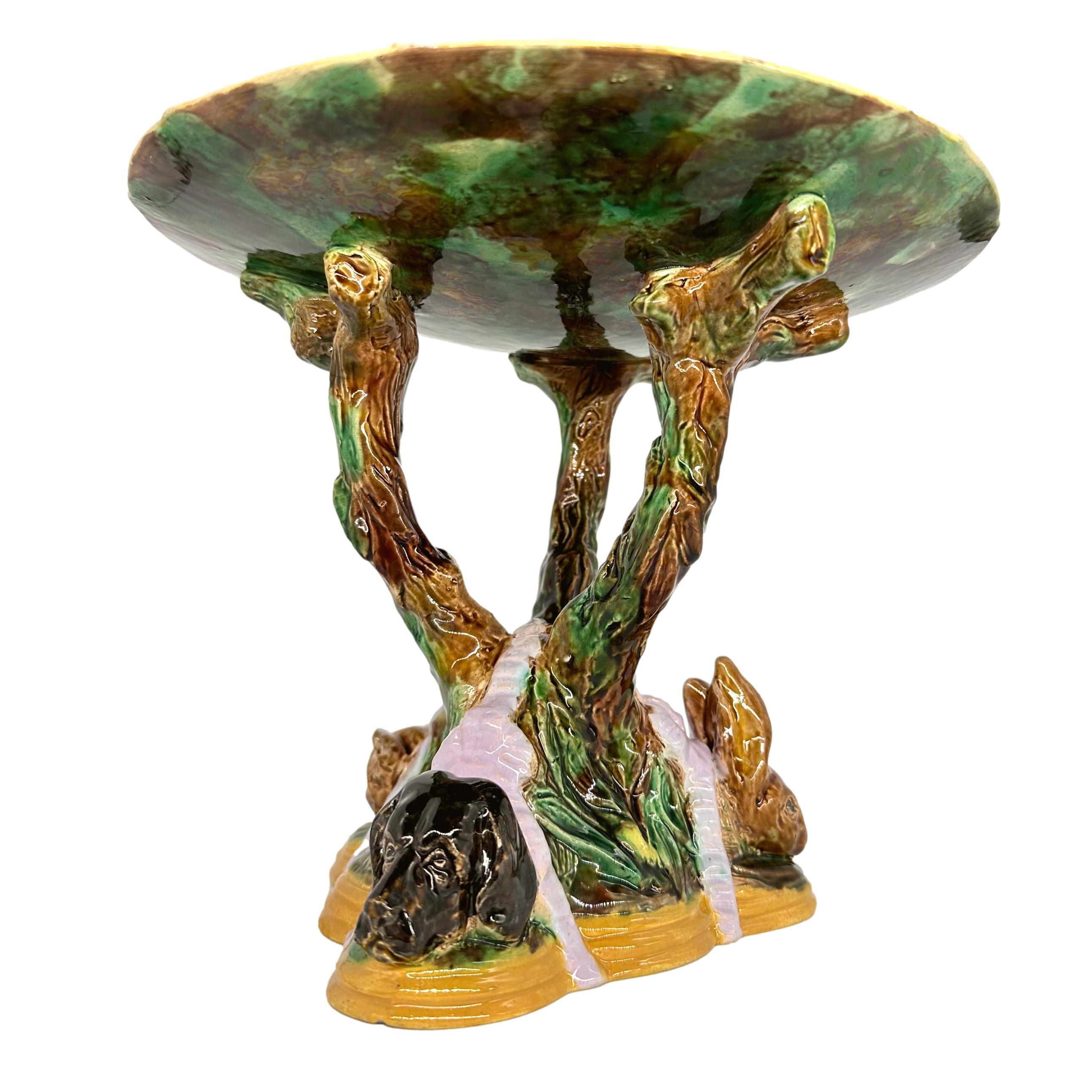 A Highly Rare and Important George Jones Majolica 
Compote/Centerpiece, with a central naturalistically molded and glazed tree trunk with three branches supporting a turquoise-ground 