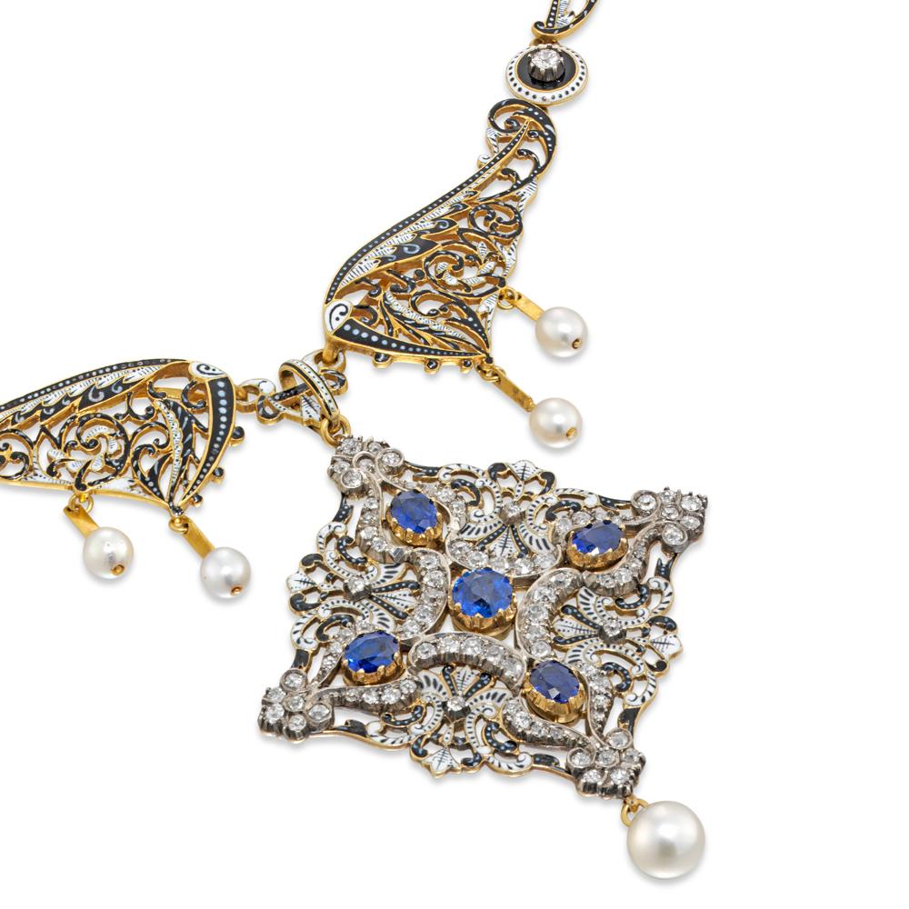 An Important Carlo and Arthur Giuliano enamel, diamond and sapphire necklace signed C & AG, the  necklace comprising pierced feathered scrollwork sections finely enamelled with black and white, linked alternately with similarly enamelled circular