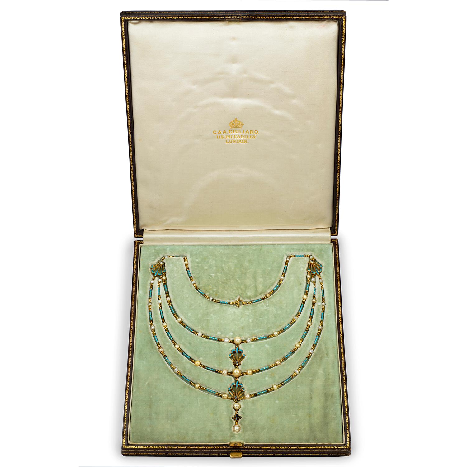 An Important Giuliano necklace, consisting of three strands of turquoise-enamelled candy-twist gold links interspersed with pearls, the three strands linked to the centre with painted enamel anthemion motifs, signed C & AG, circa 1900, gross weight