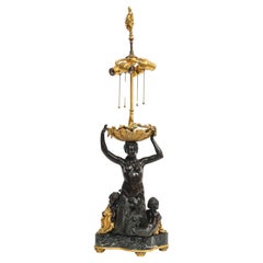 Un'importante lampada figurativa a forma di sirena in bronzo patinato e dorato di E. F. Caldwell