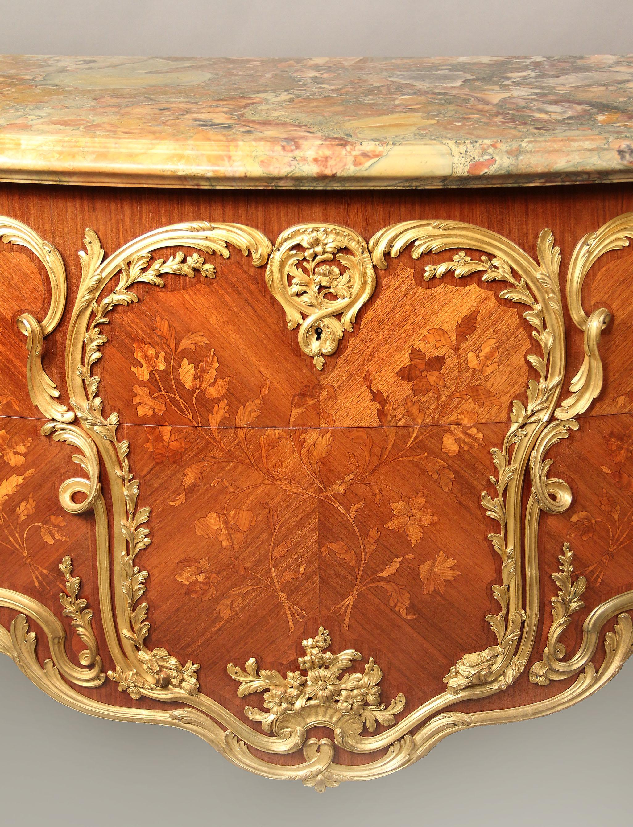 An important late 19th century Louis XV style gilt bronze mounted inlaid floral Marquetry commode by Antoine Krieger

Antoine Krieger

A finely cut marble top above two deep long drawers with inlaid floral marquetry panels and heavy gilt bronze