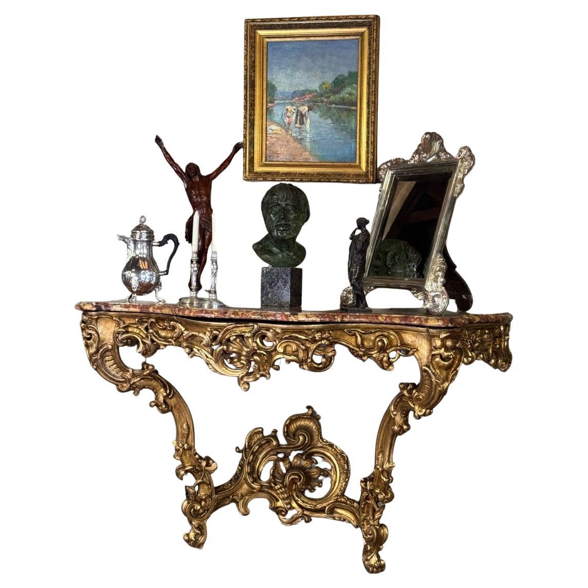 An important Louis XV carved and gilded wood and Breche d'Alep marble console ta