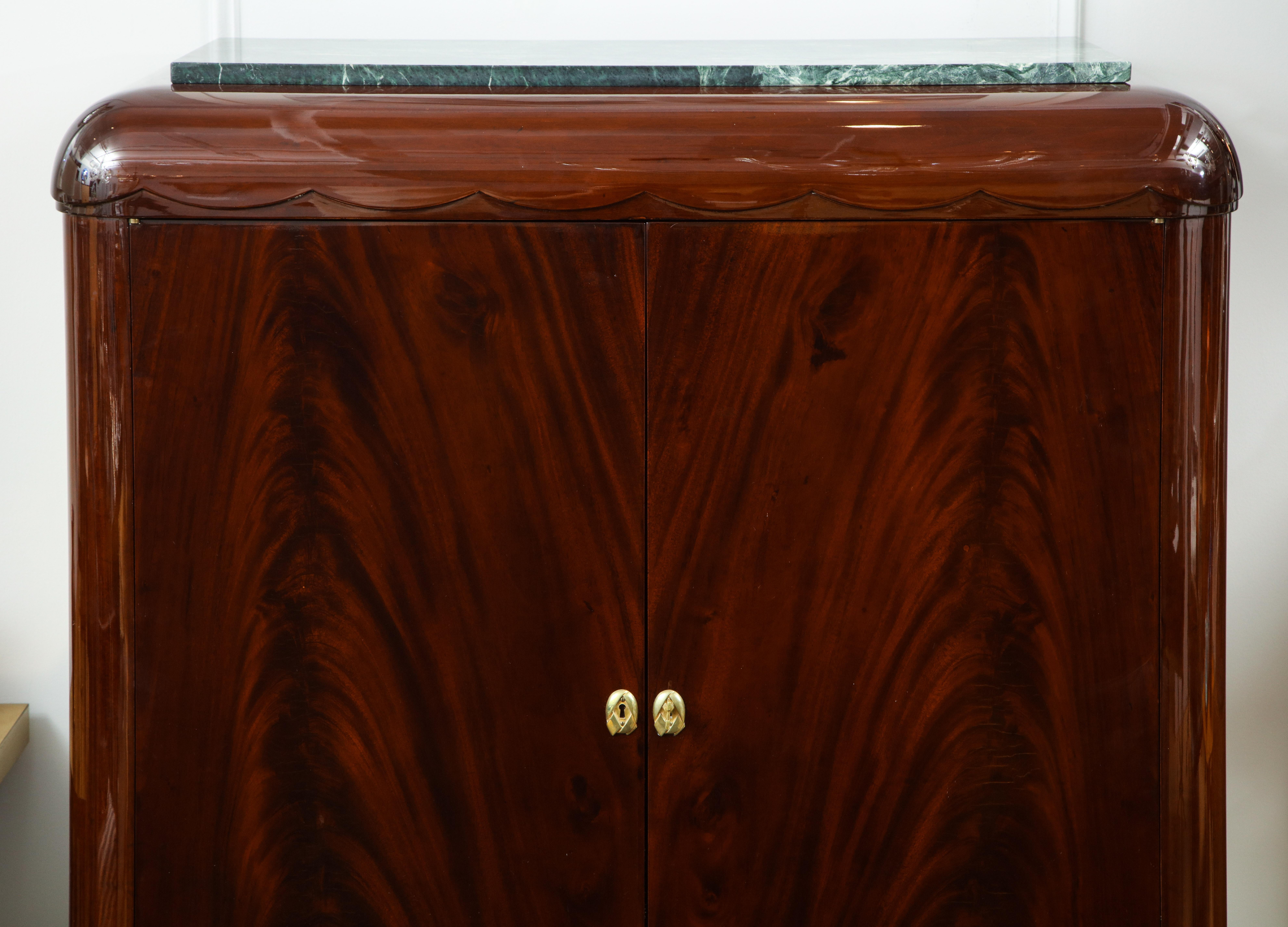 The later marble resting on a rounded scalloped mahogany top over 2 doors with bronze escutcheons. opening to a fitted interior, the whole supported by a rounded Greek key foot.
References can be found in 