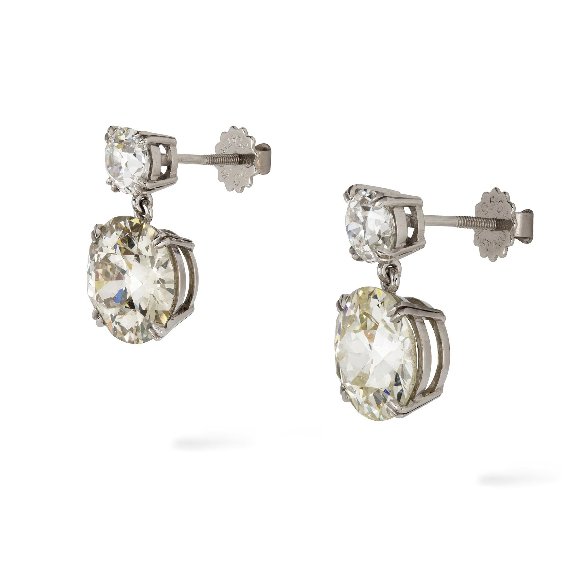 A pair of diamond drop earrings, the two round shape old-cut diamonds, weighing 4.26 carats of M colour and P1 clarity and 4.85 carats of L colour and SI1 clarity, each suspended from a smaller old-cut diamond, weighing 0.91 and 0.86 carats, all