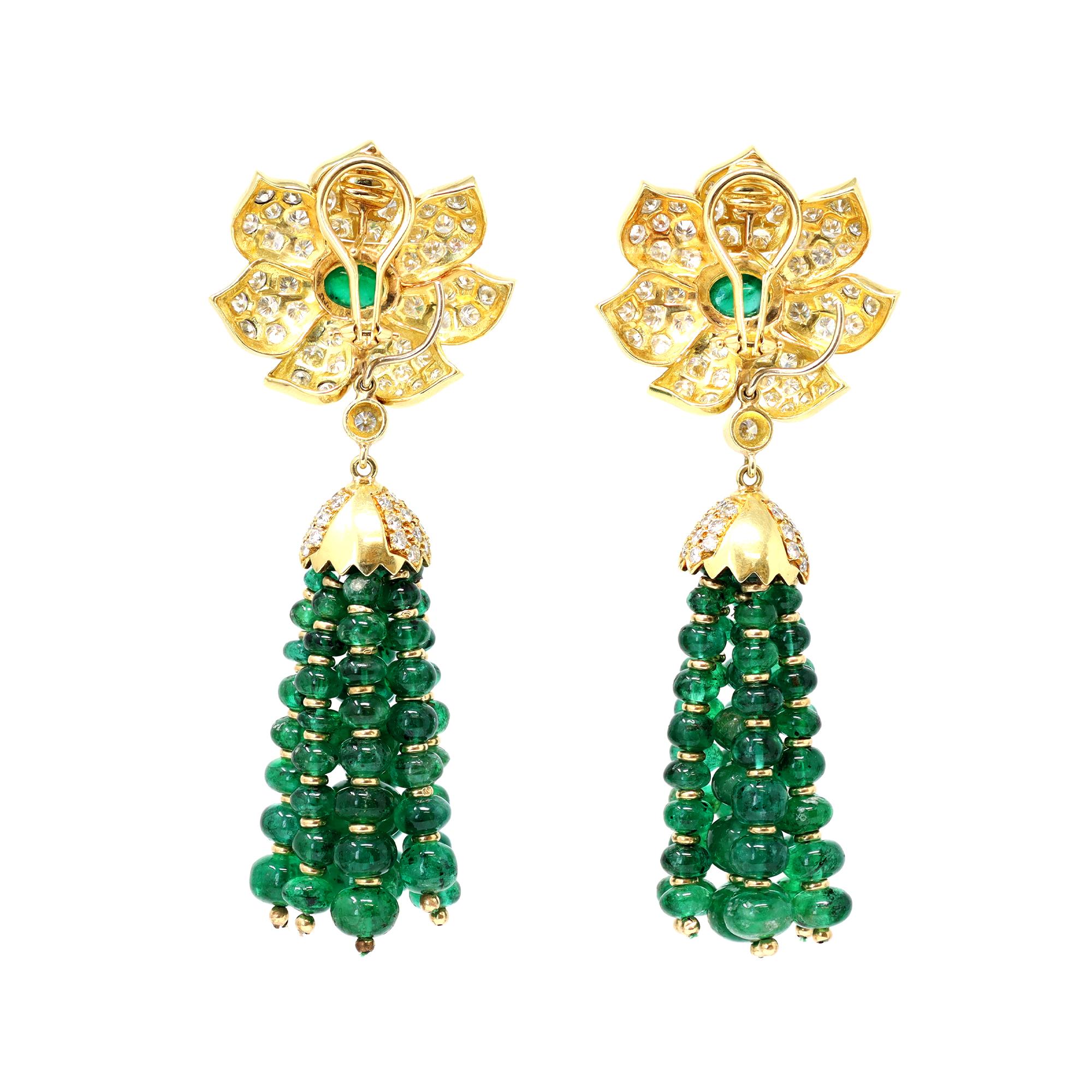 A vintage spectacular Pair of emerald bead Tassel and diamond earclips, Day and Night, set in 18 karat yellow gold. The earrings are circa 1970-80, featuring at the top a flower design with a cabochon emerald in its center and diamonds set in a