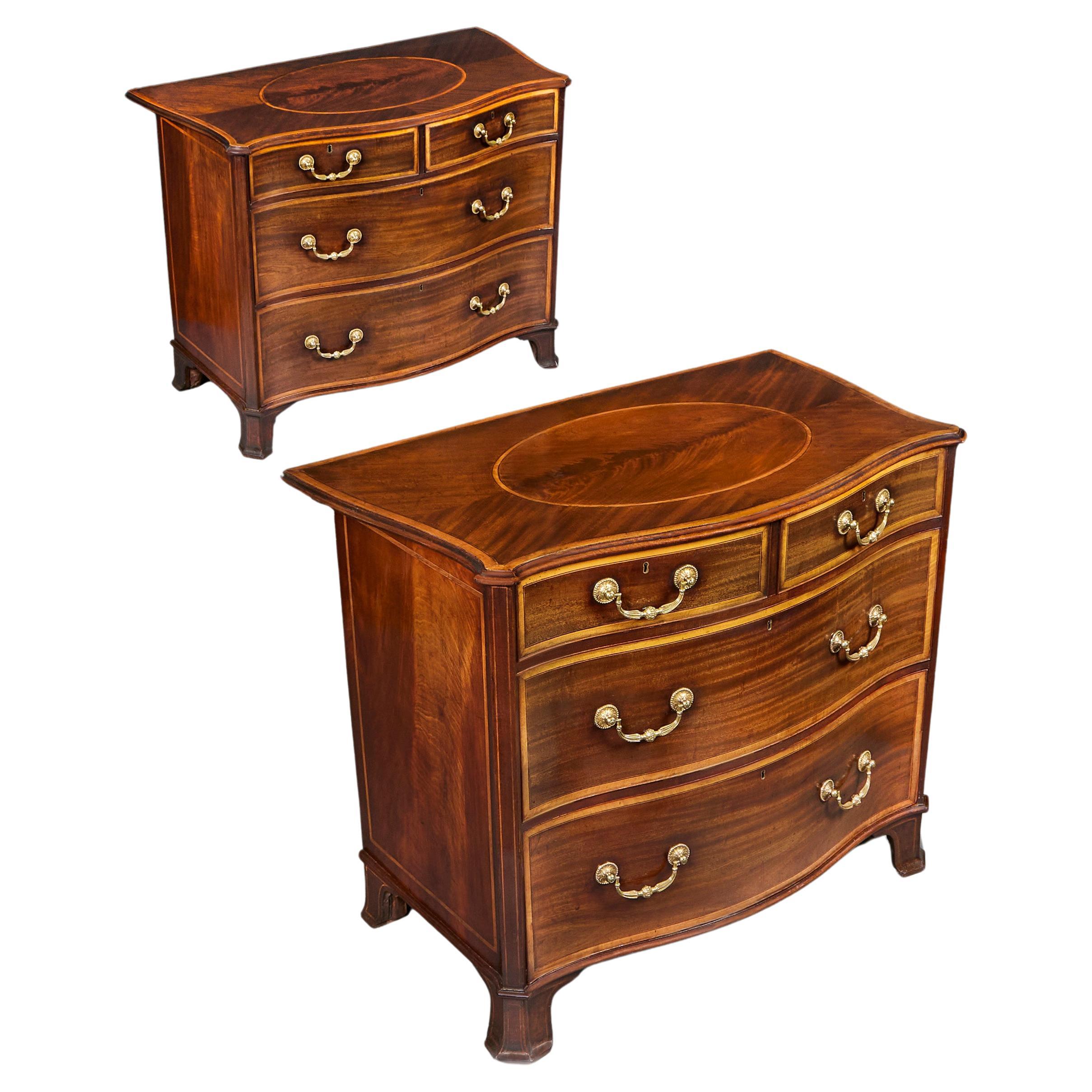 An Important pair of George III Serpentine Commodes