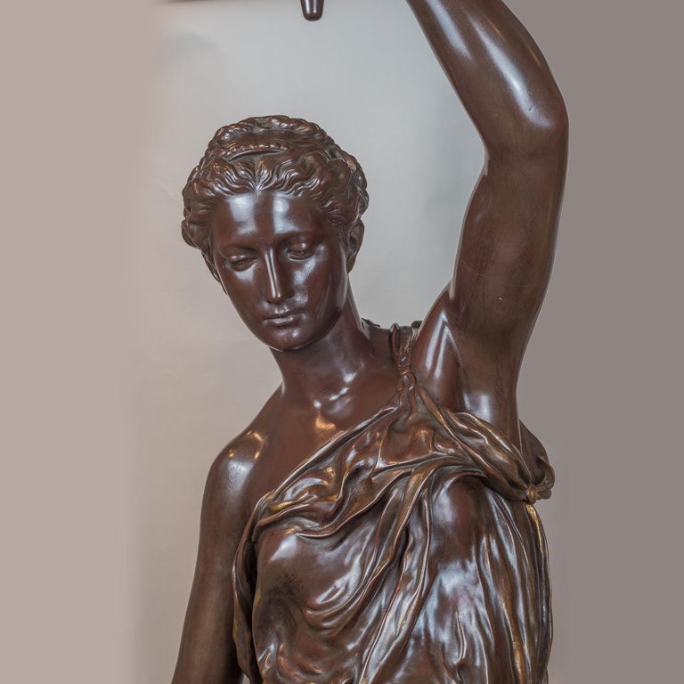 Mounted as lamps and cast by Ferdinand Barbedienne after models by Alexandre Falguiere and Paul Dubois. Both statues are signed on the bases. 

These fine torchères are reductions of a pair exhibited by Dubois at the 1867 Exposition Universelle,