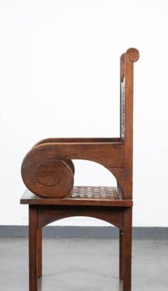 an important sculpted armchairs in oak by Jacques PHILIPPE